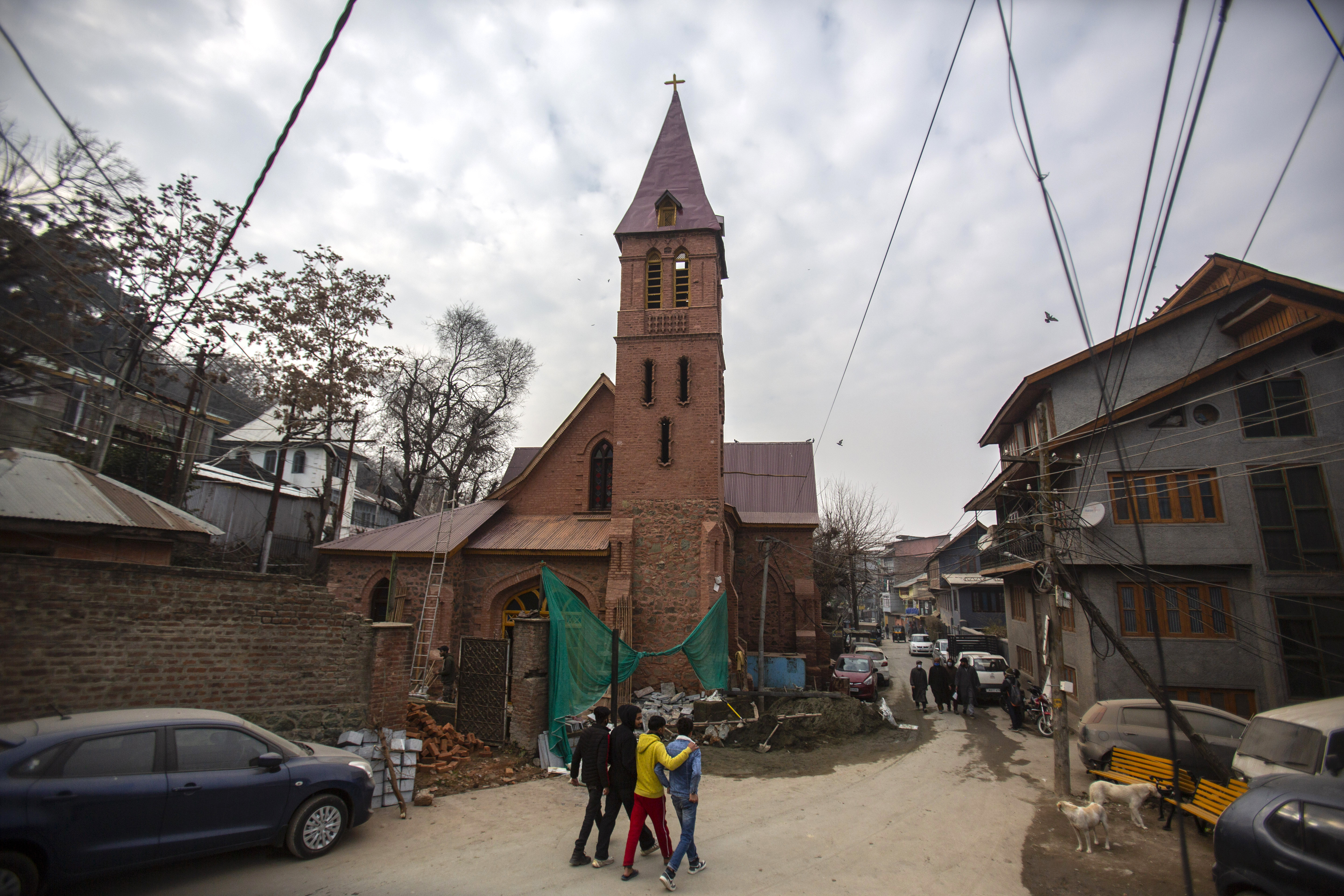 Kashmiri boys walk past the 125-year-old Saint Luke’s church in Srinagar