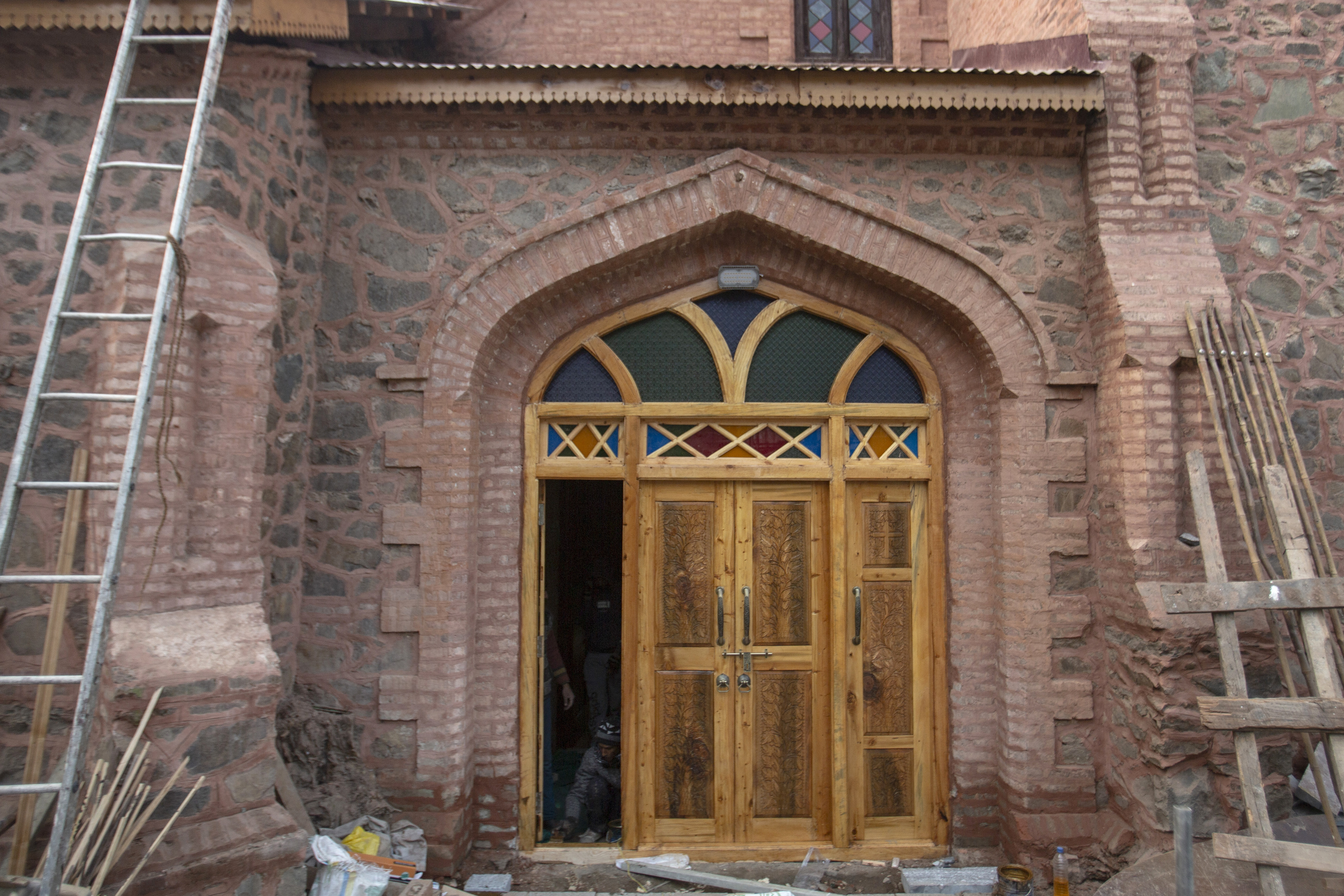 Kashmiri masons work at the entrance of the historic church