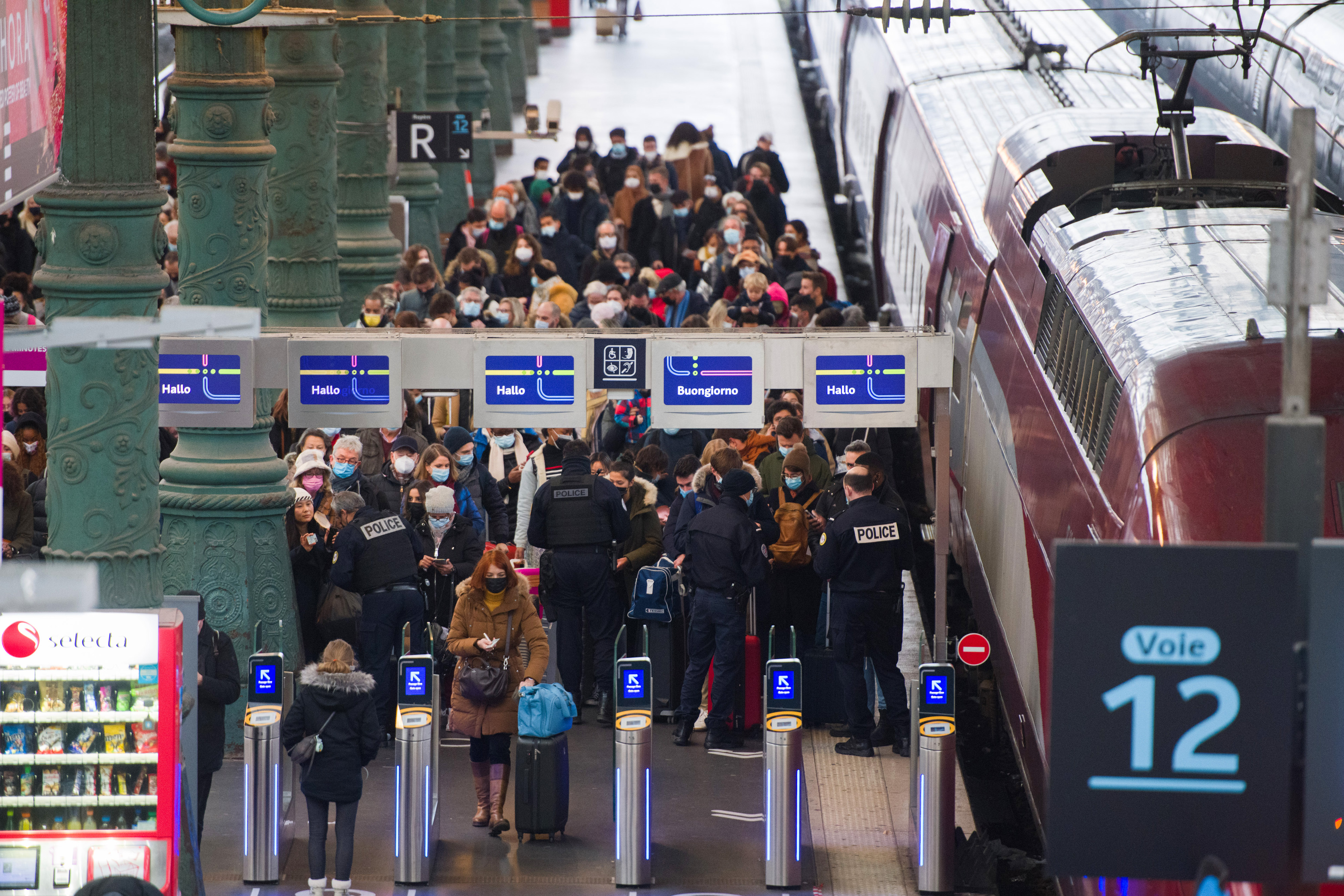 French border police check the COVID health passes of travellers on the Thalys arrivals platform at Gare du Nord train station in Paris, France