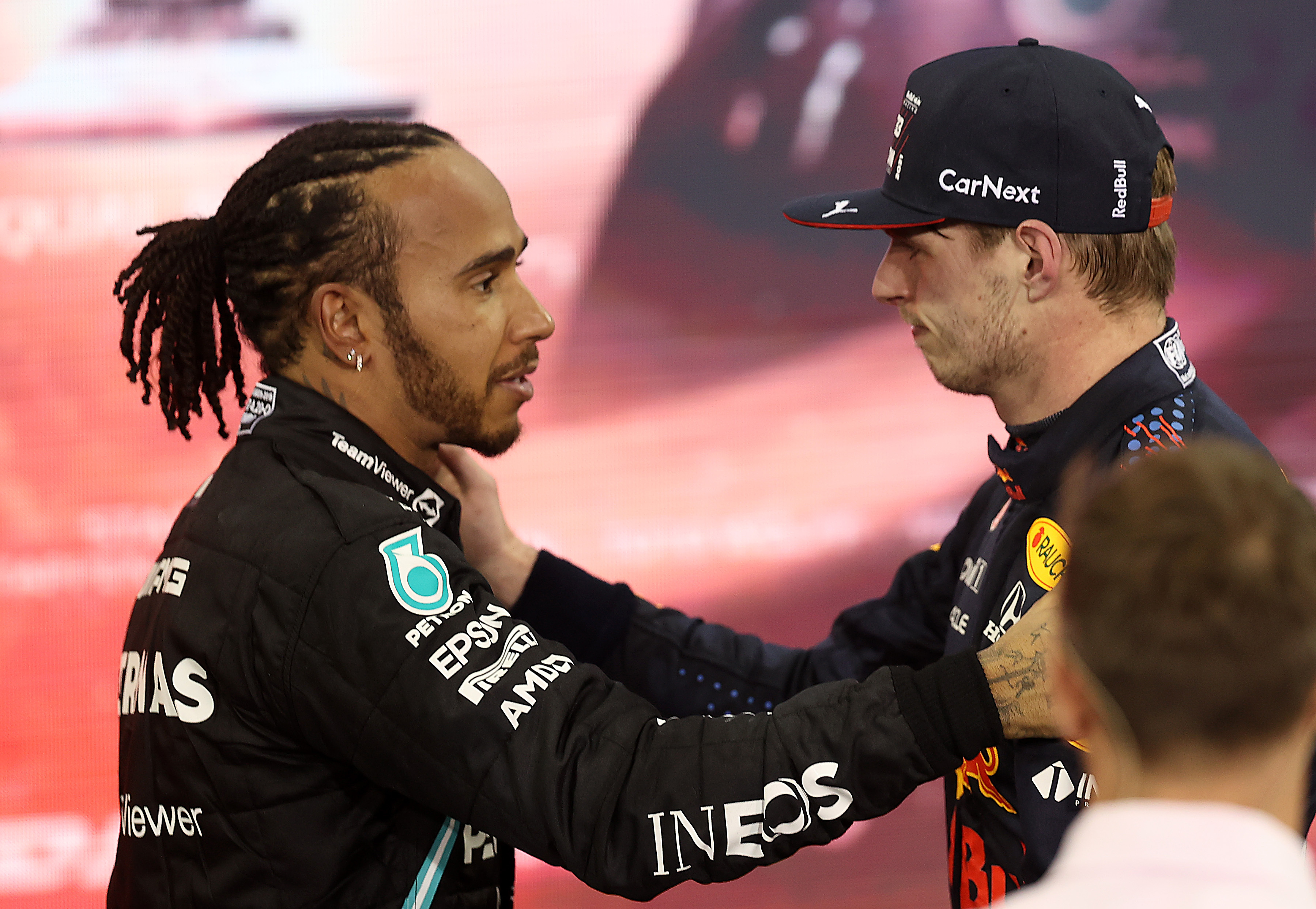 Race winner and 2021 F1 World Drivers Champion Max Verstappen of Netherlands and Red Bull Racing is congratulated by runner-up in the race and championship Lewis Hamilton