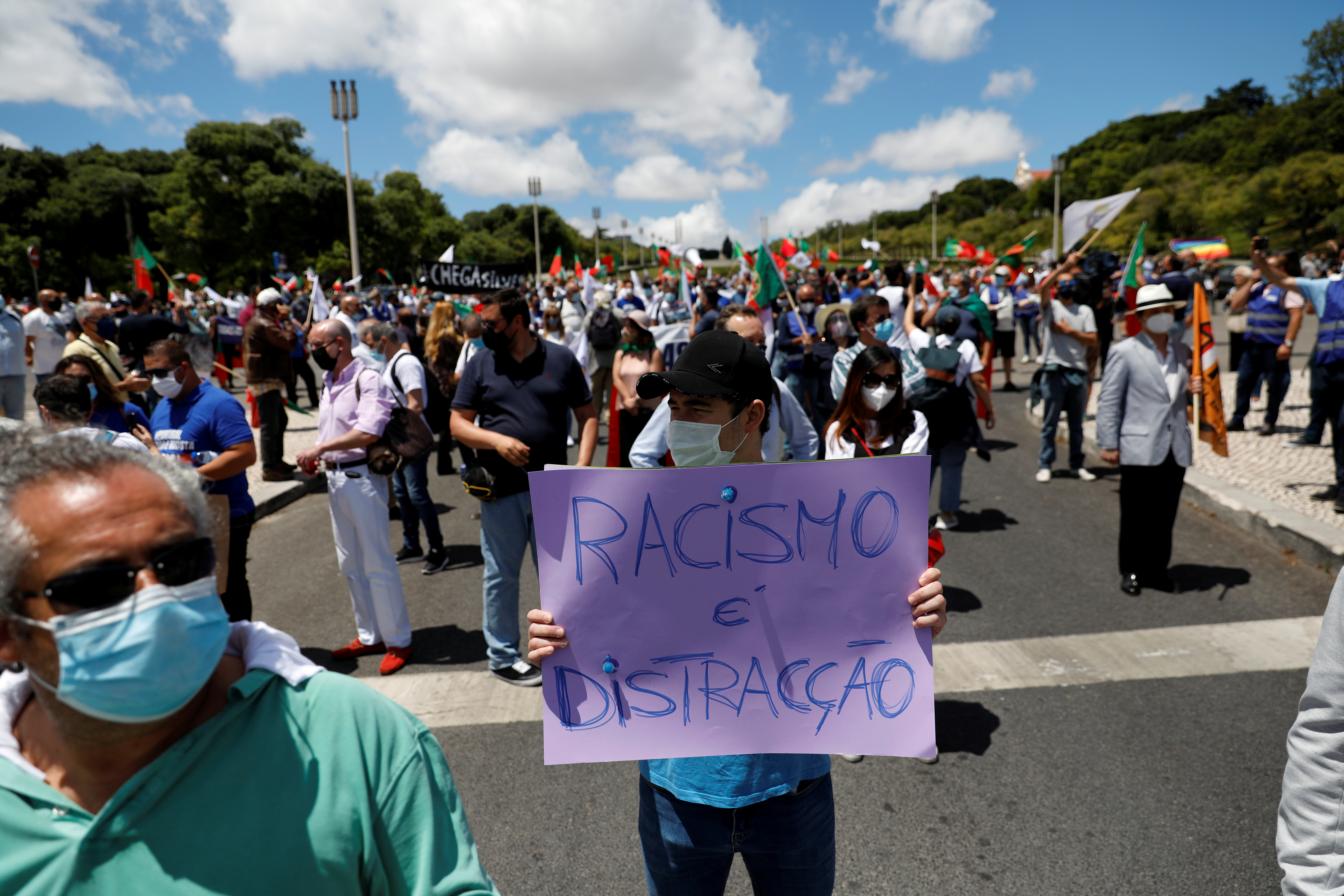 RA Chega supporter holds a placard reading ‘racism is distraction’ at a protest in Lisbon against those who say racism exists in the country