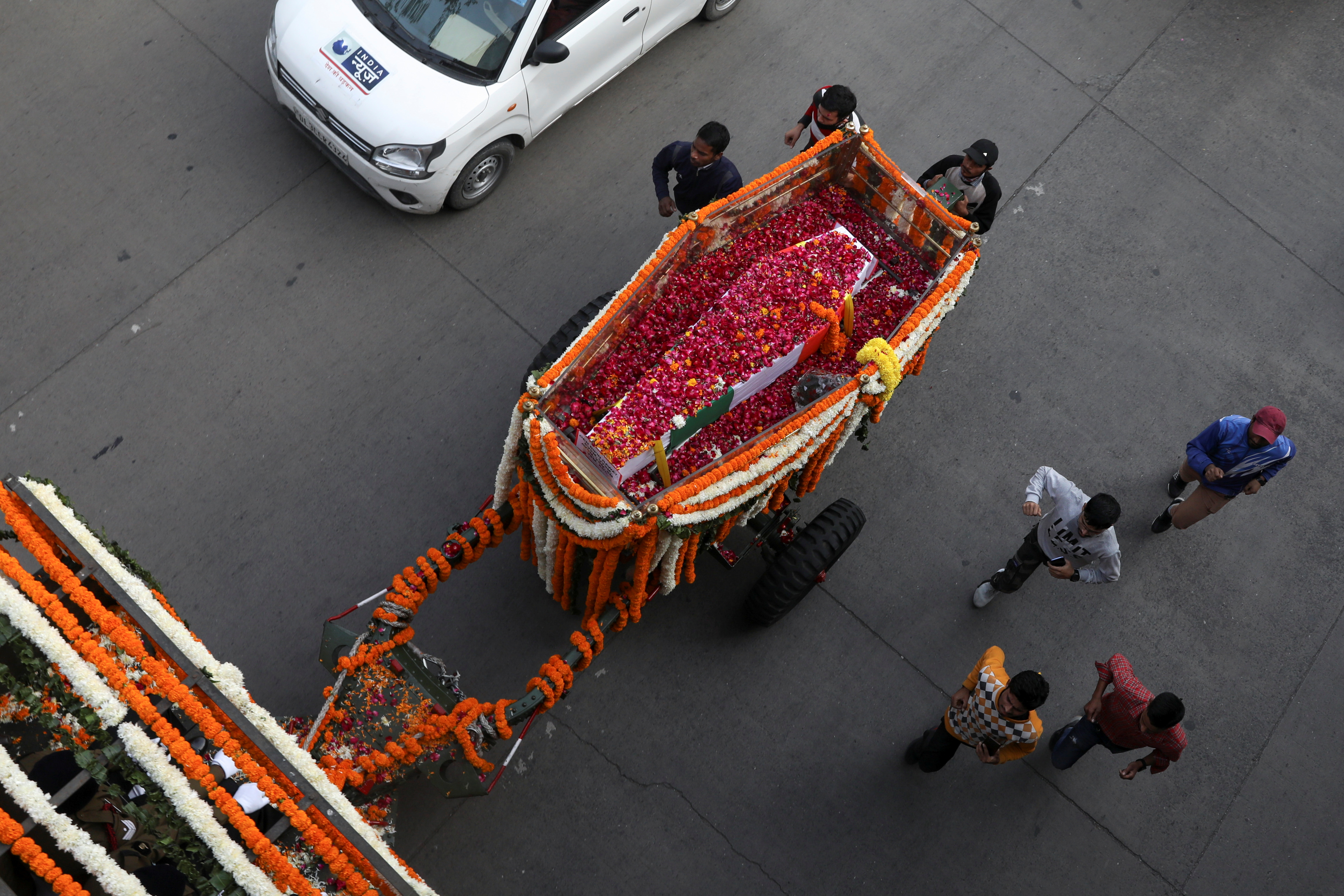 The coffin of India’s Chief of Defence Staff General Bipin Rawat travelled through New Delhi pulled behind a military vehicle