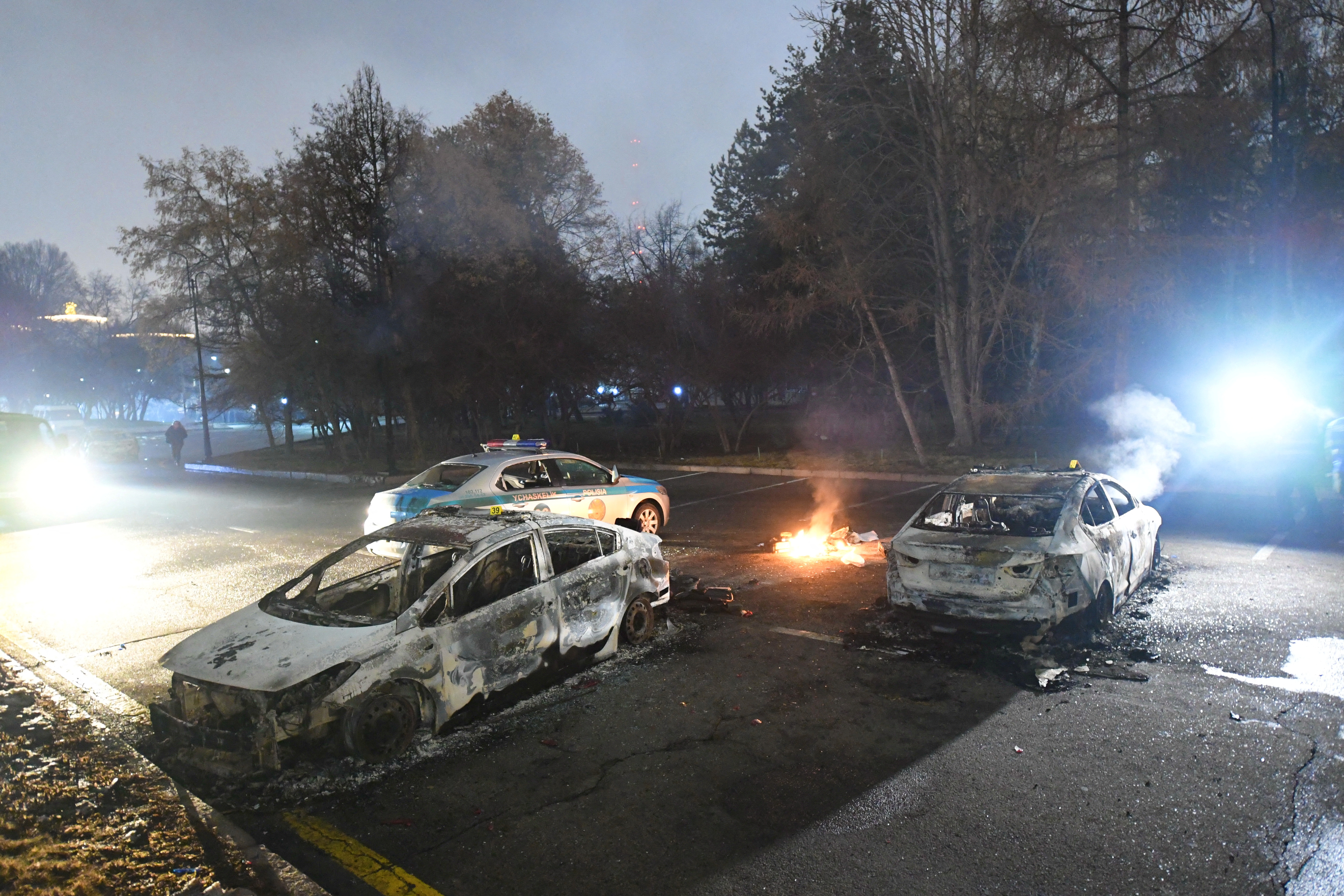 Damaged cars are seen near the mayor’s office during protests triggered by fuel price increase in Almaty, Kazakhstan