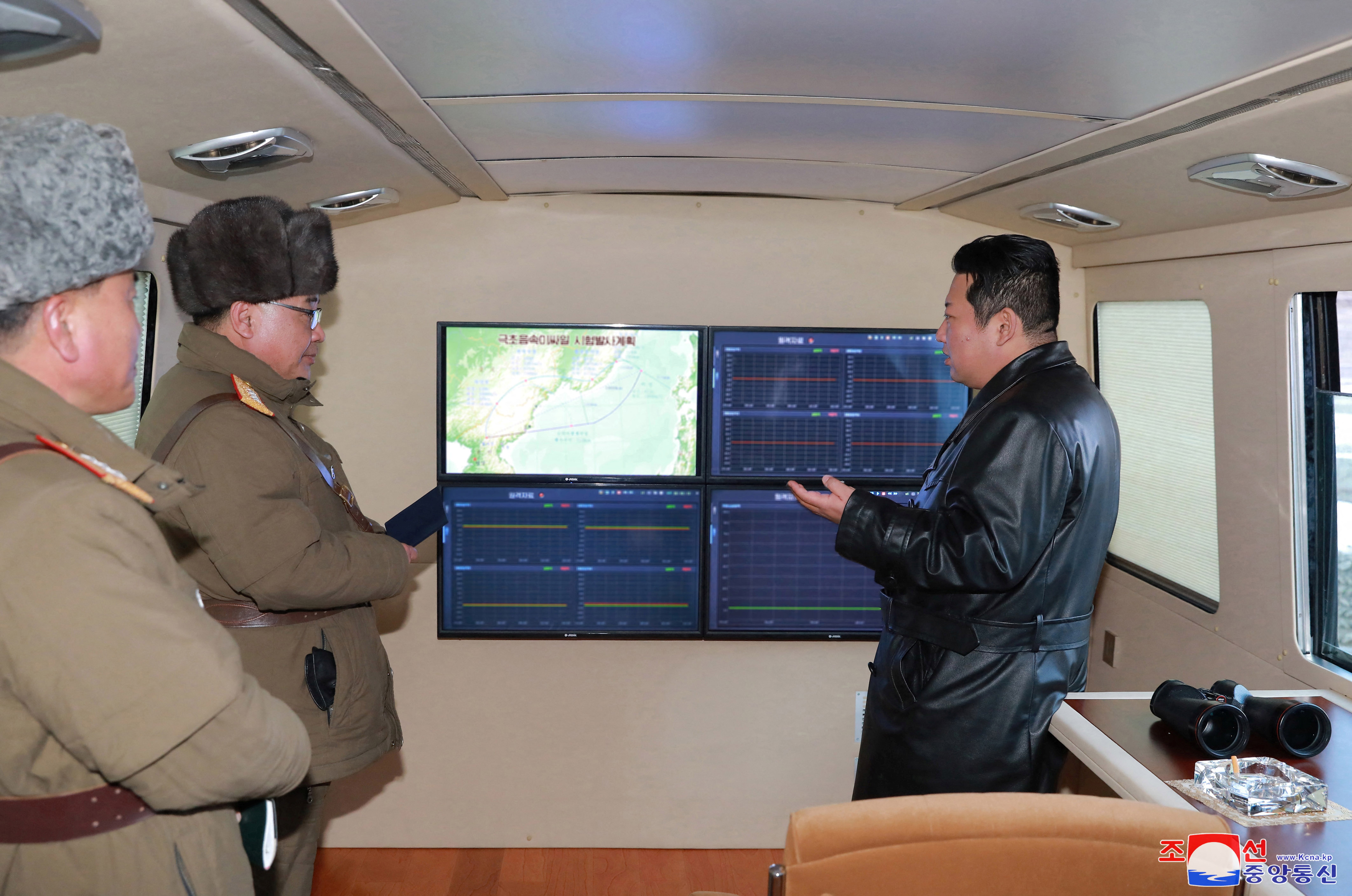 North Korean leader Kim Jong Un speaks with officials during an observation of what state media report is a hypersonic missile test at an undisclosed location in North Korea on January 11, 2022 [KCNA via Reuters]