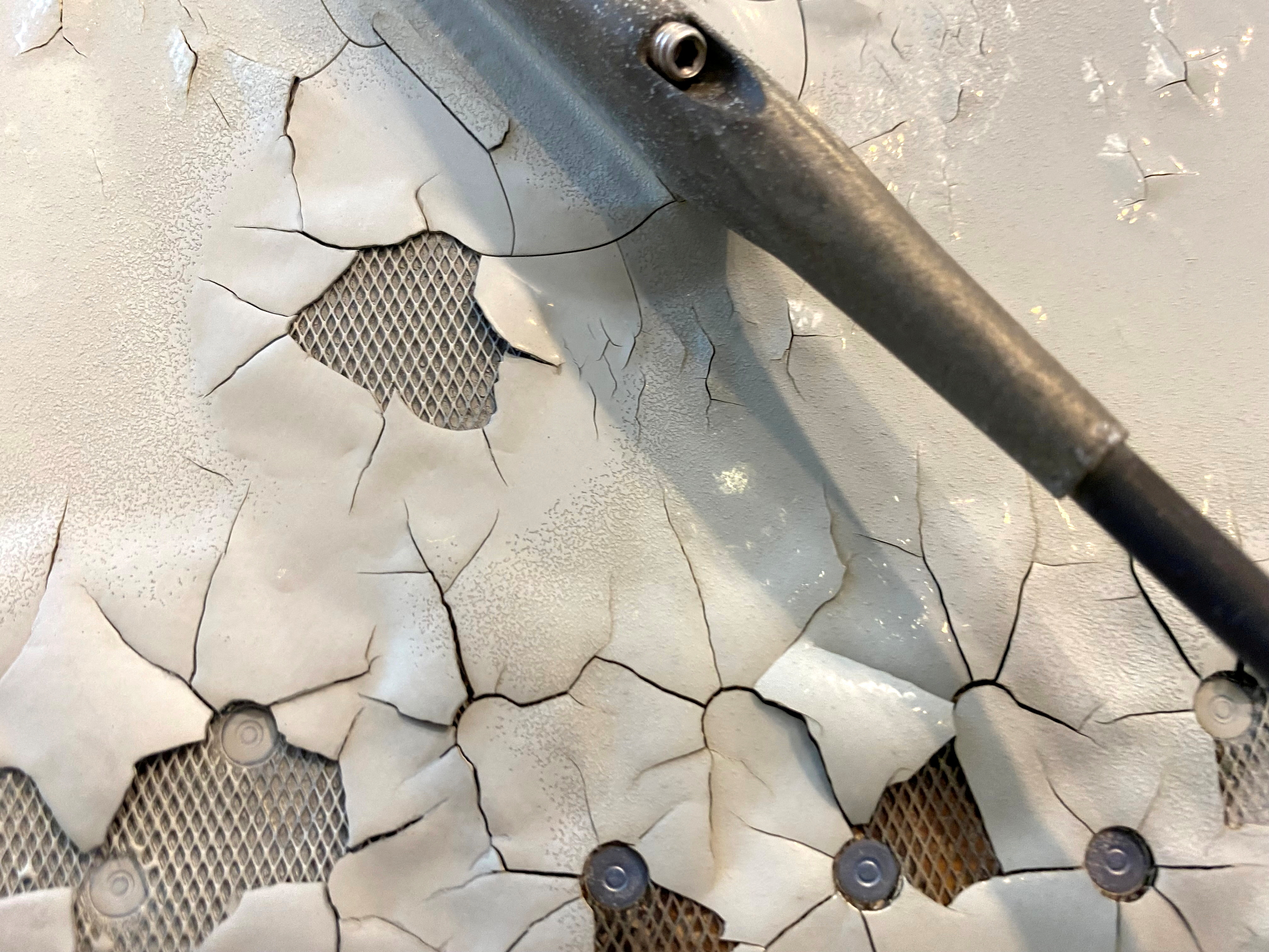 An undated image shows what appears to be paint peeling, cracking and exposed expanded copper foil on the fuselage of a Qatar Airways A350 aircraft