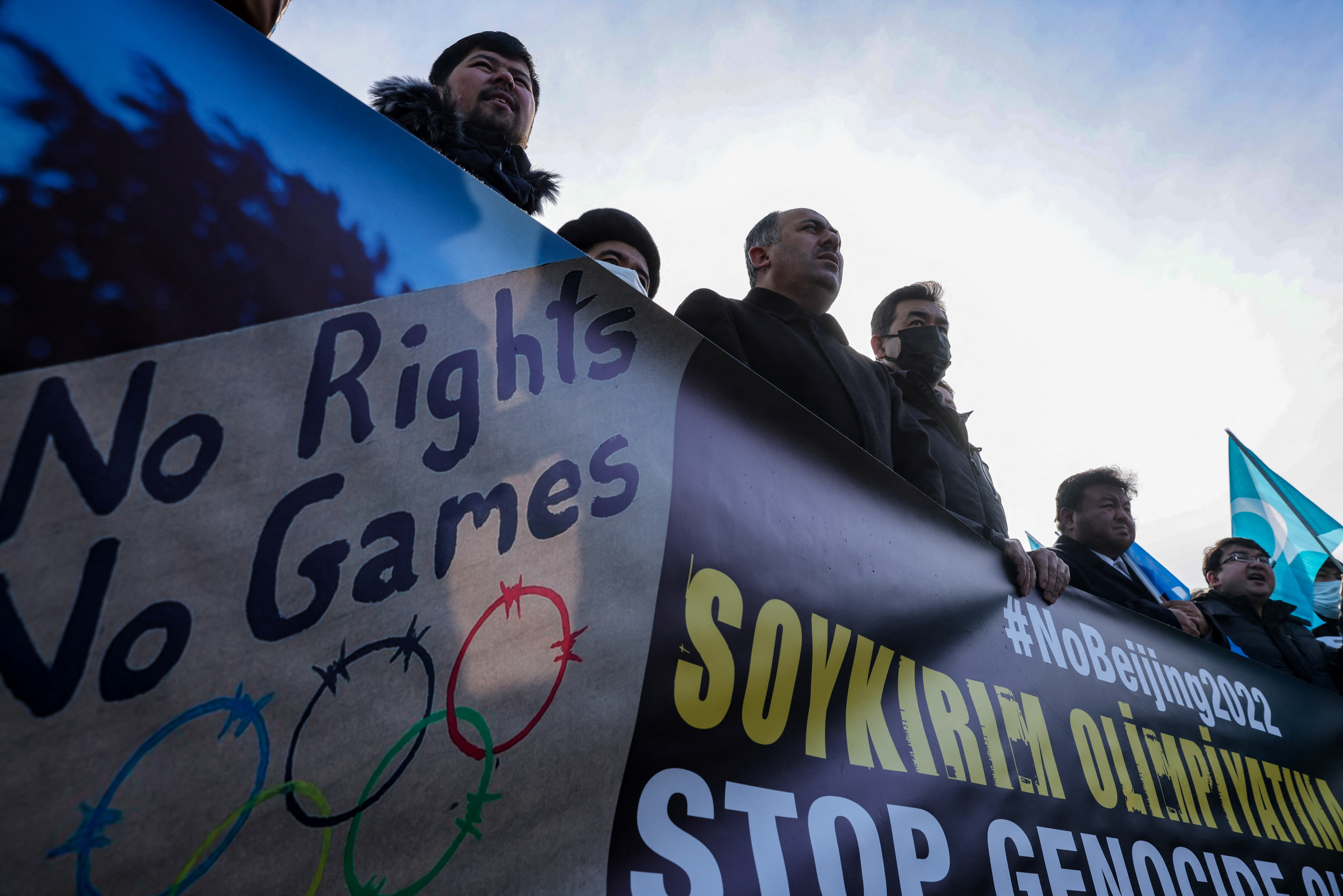 People from China's Uyghur Muslim ethnic group protest outside the city's Turkish Olympic Committee building