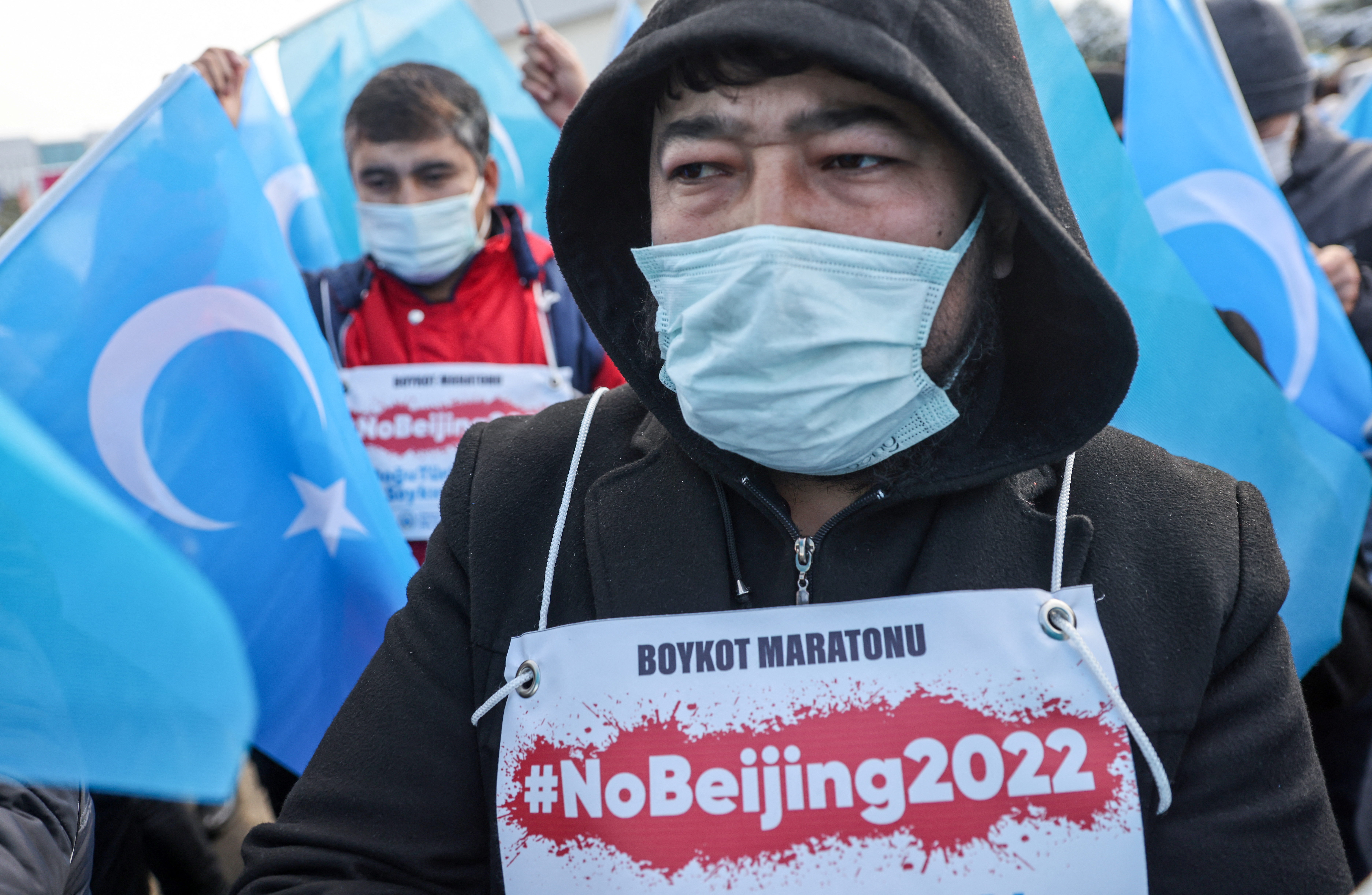 People from China's Uyghur Muslim ethnic group protest outside the city's Turkish Olympic Committee building