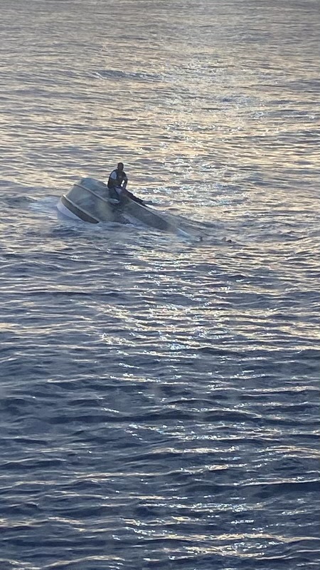 A man was found on the hull of a capsized boat off the Florida coast. He told the Coast Guard he was one of a group of 40 who left the Bahamas on Saturday [US Coast Guard via Reuters]