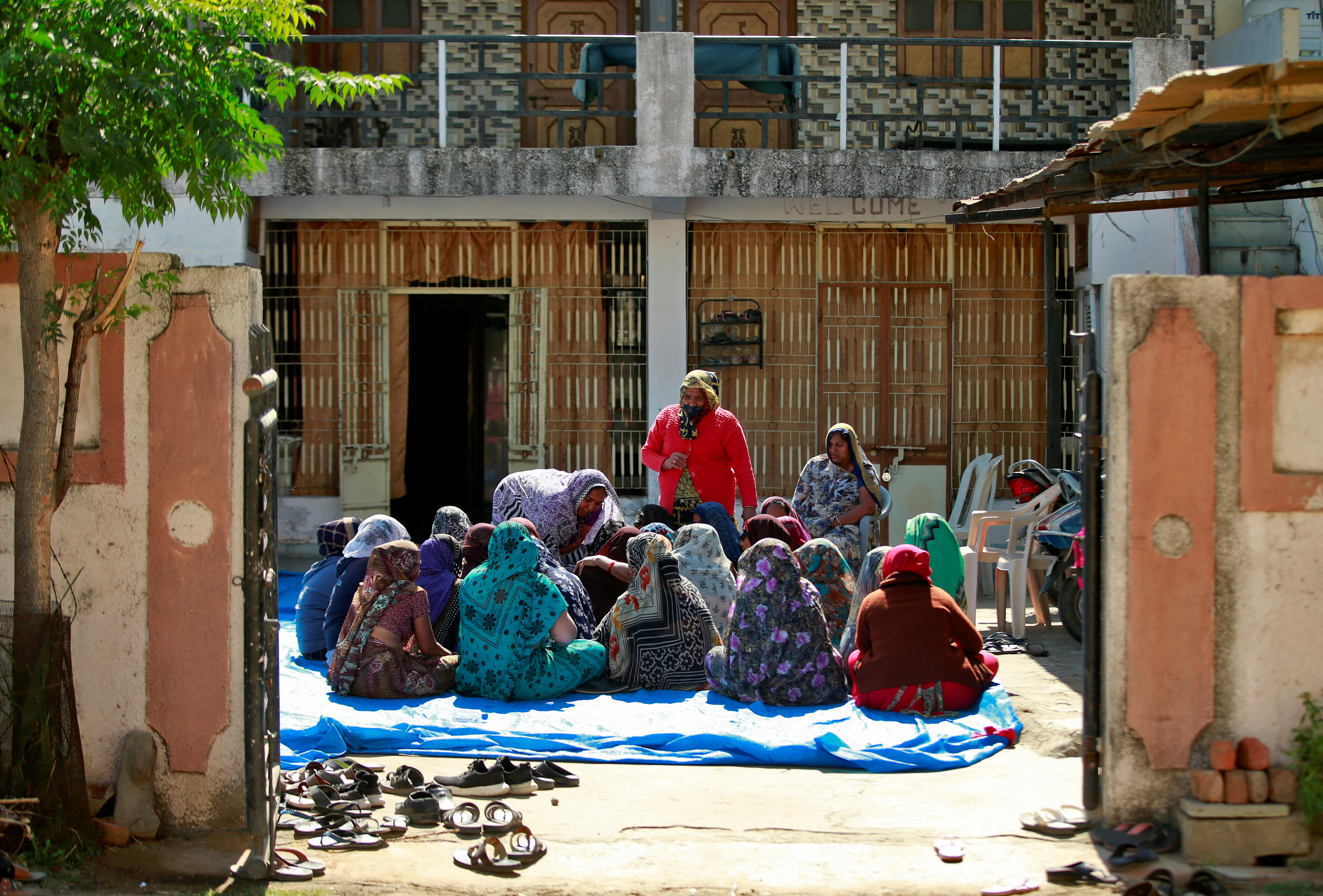 Relatives of the Patel family gather to mourn the deaths at Dingucha village in the western Indian state of Gujarat