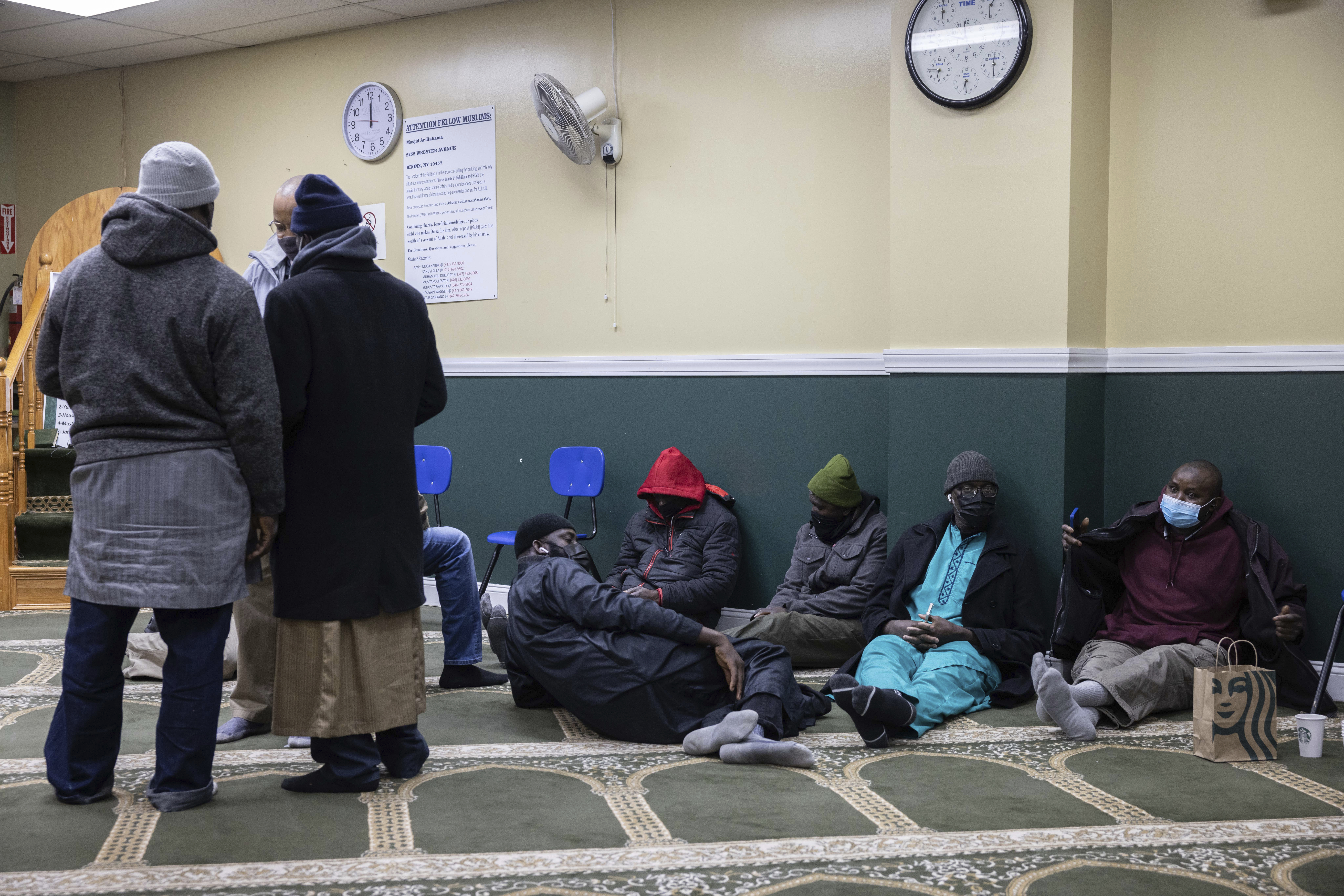Family members gather and wait for information about missing loved ones at Masjid-Ur-Rahmah near the apartment building in the Bronx borough of New York City, January 10, 2022