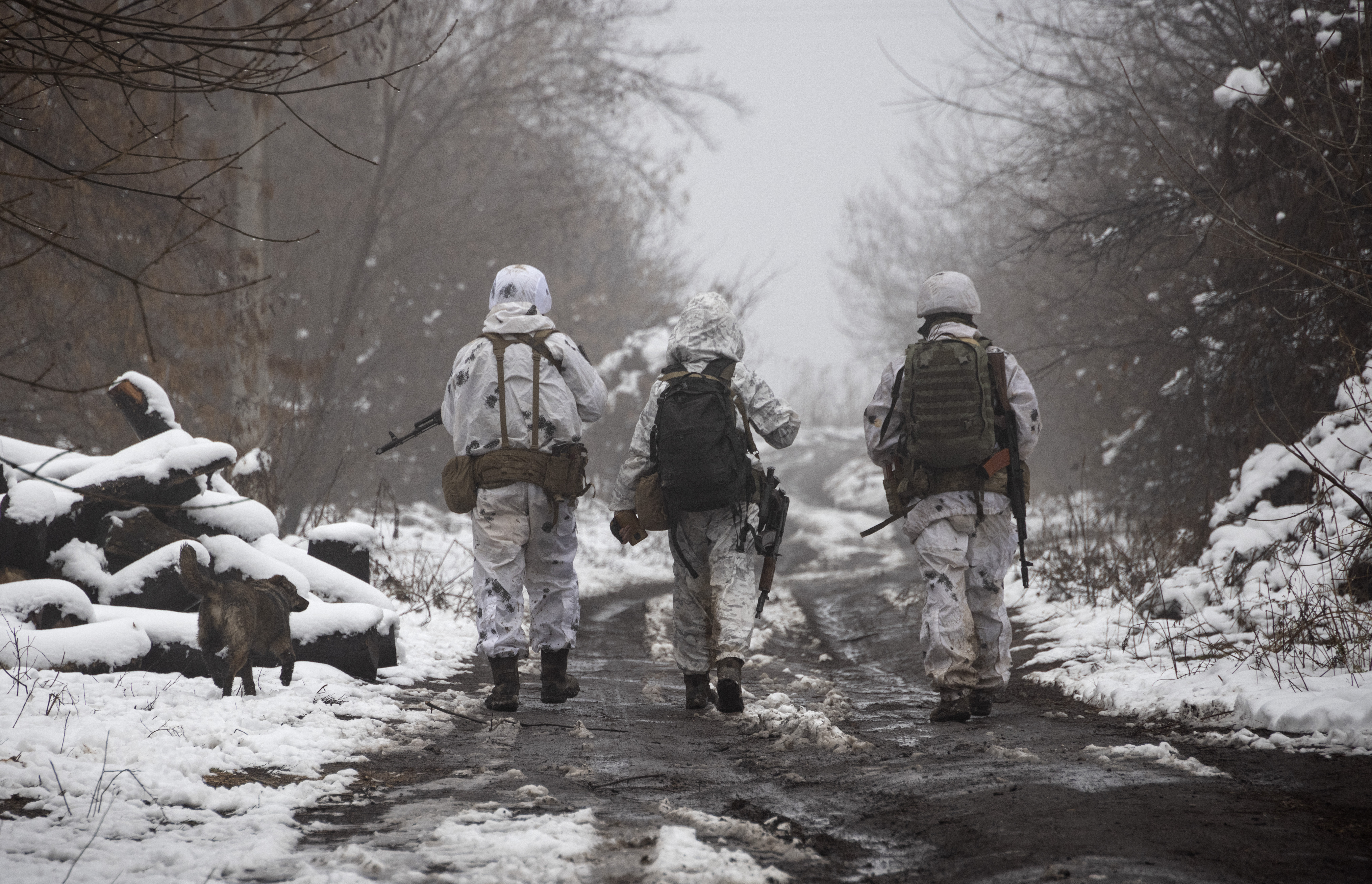 Ukrainian soldiers walk at the line of separation from pro-Russian rebels near Katerinivka, in Ukraine's Donetsk region