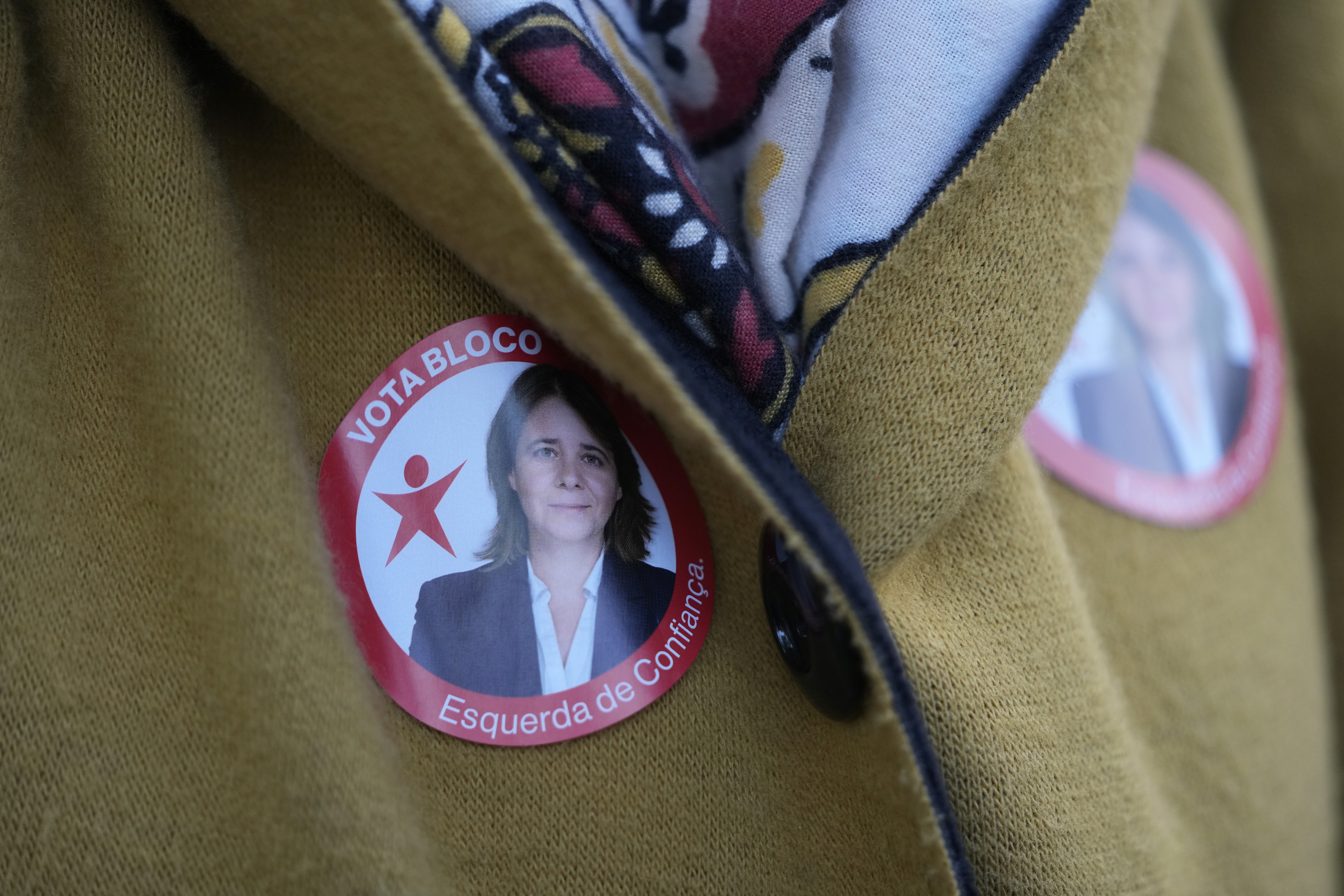 A woman wears stickers with a picture of Left Bloc leader Catarina Martins during an election campaign event in a street of Lisbon