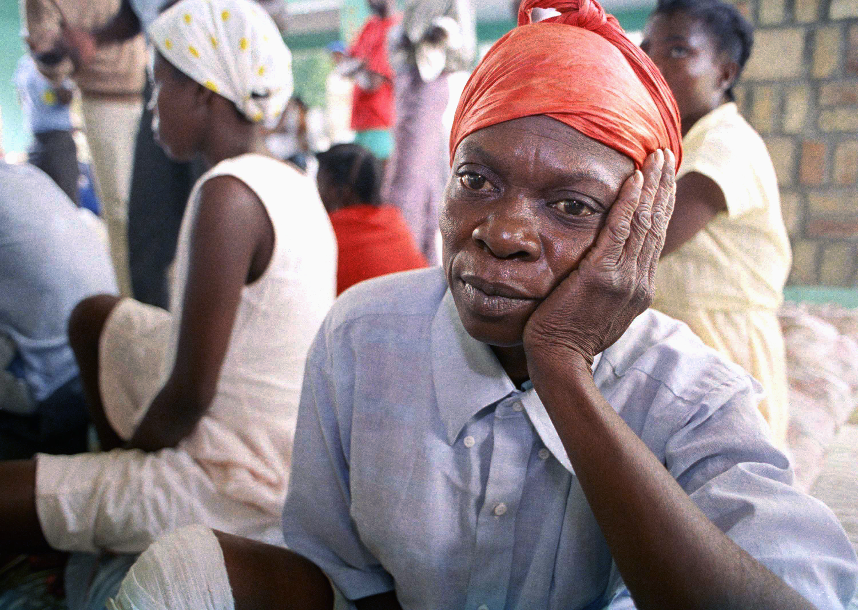 A Haitian refugee waits to be interrogated by immigration officials at a dock in Port-au-Prince, on February 3, 1992. The first group of 164 Haitian refugees arrived from the US Naval Base at Guantanamo Bay, Cuba, on a US coastguard cutter after the US Supreme Court ruled that the US government could resume forced deportations of Haitian boat people