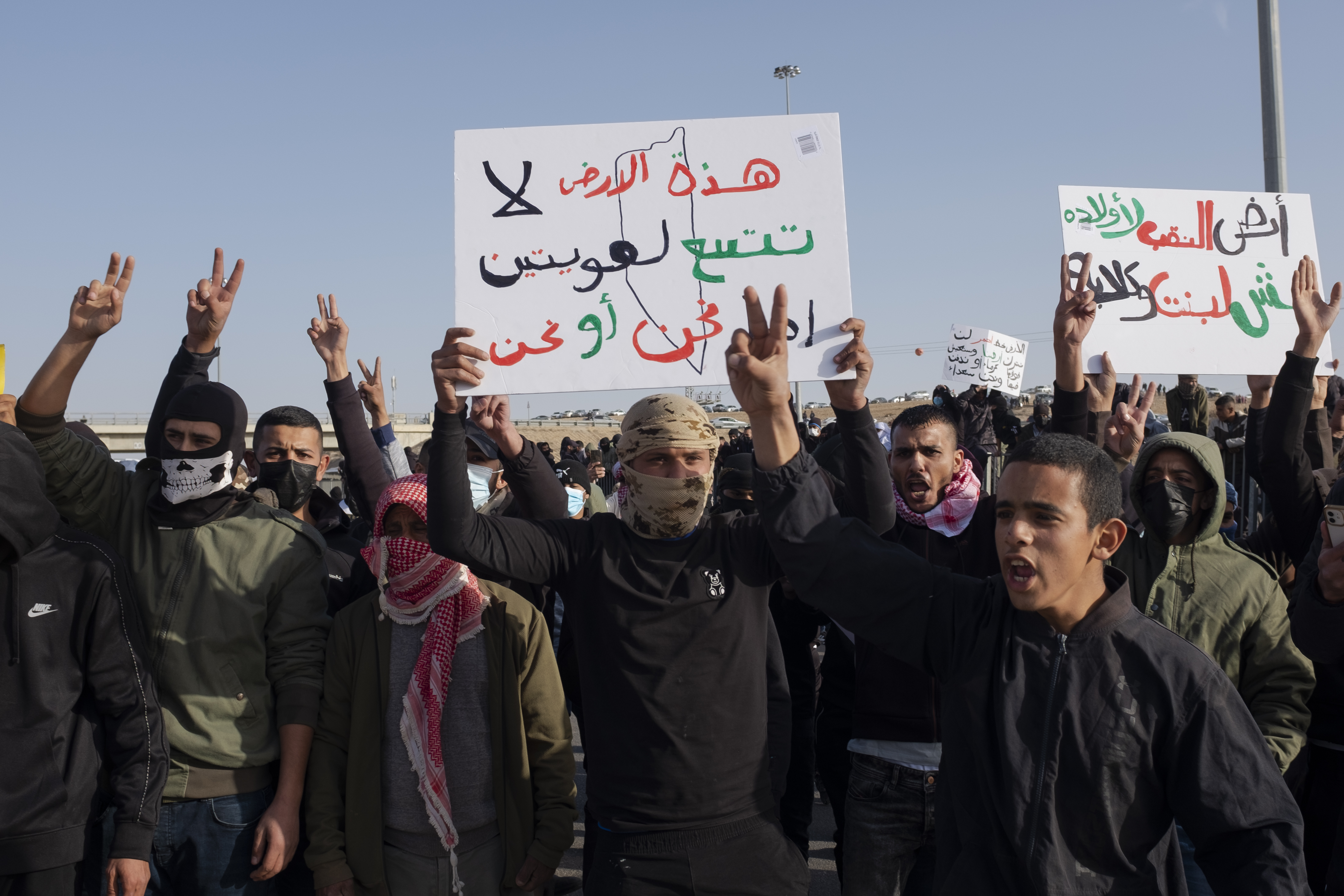 Protesters held up signs saying, ‘The Naqab’s land are for its people,’ during Thursday’s demonstration [Al Jazeera]