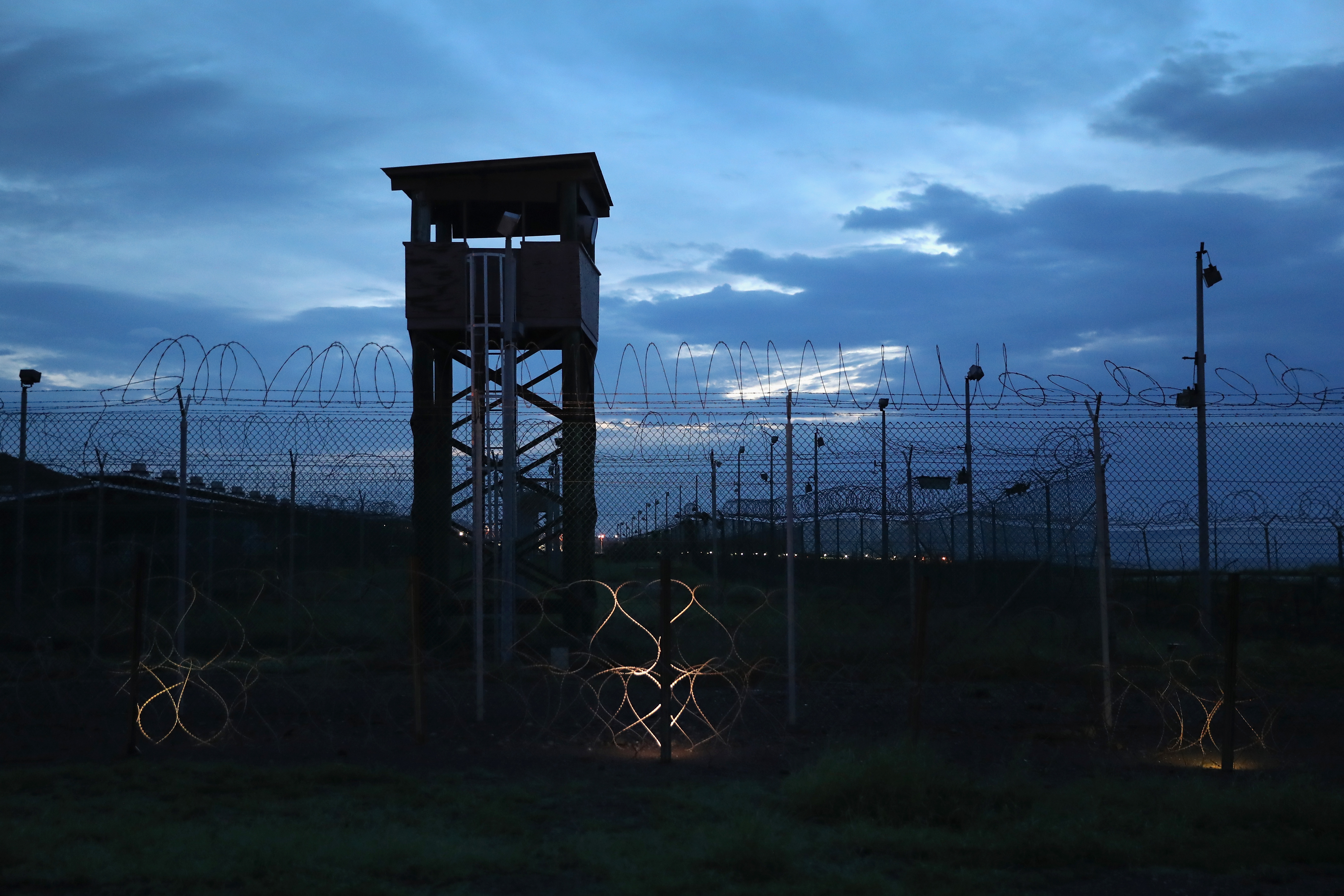 Razor wire and a guard tower stands at a closed section of the US Naval Station at Guantanamo Bay, Cuba, on October 22, 2016