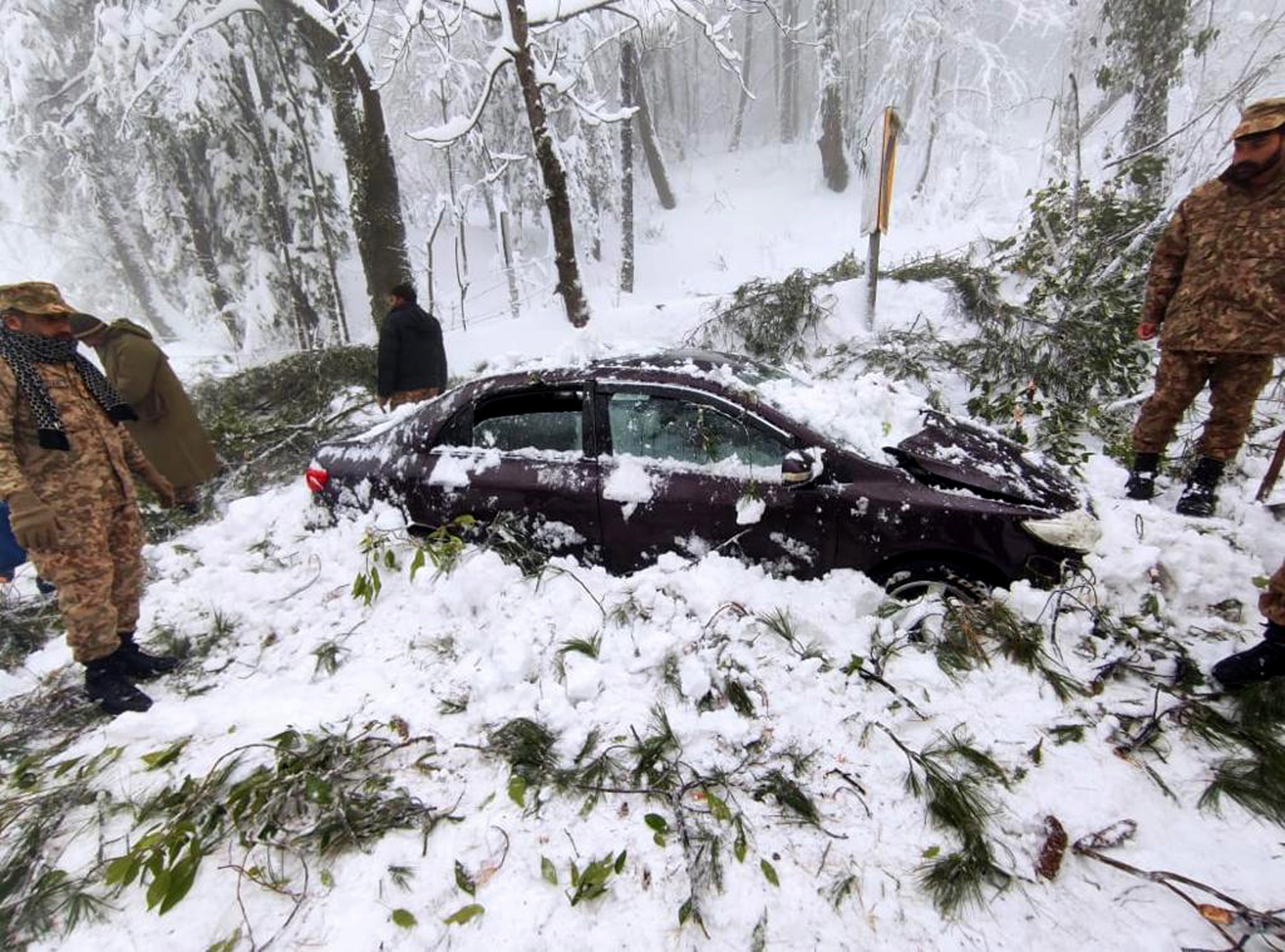 Pakistani army soldiers take part in rescue works after 16 tourists died amid heavy snowfall in Murree