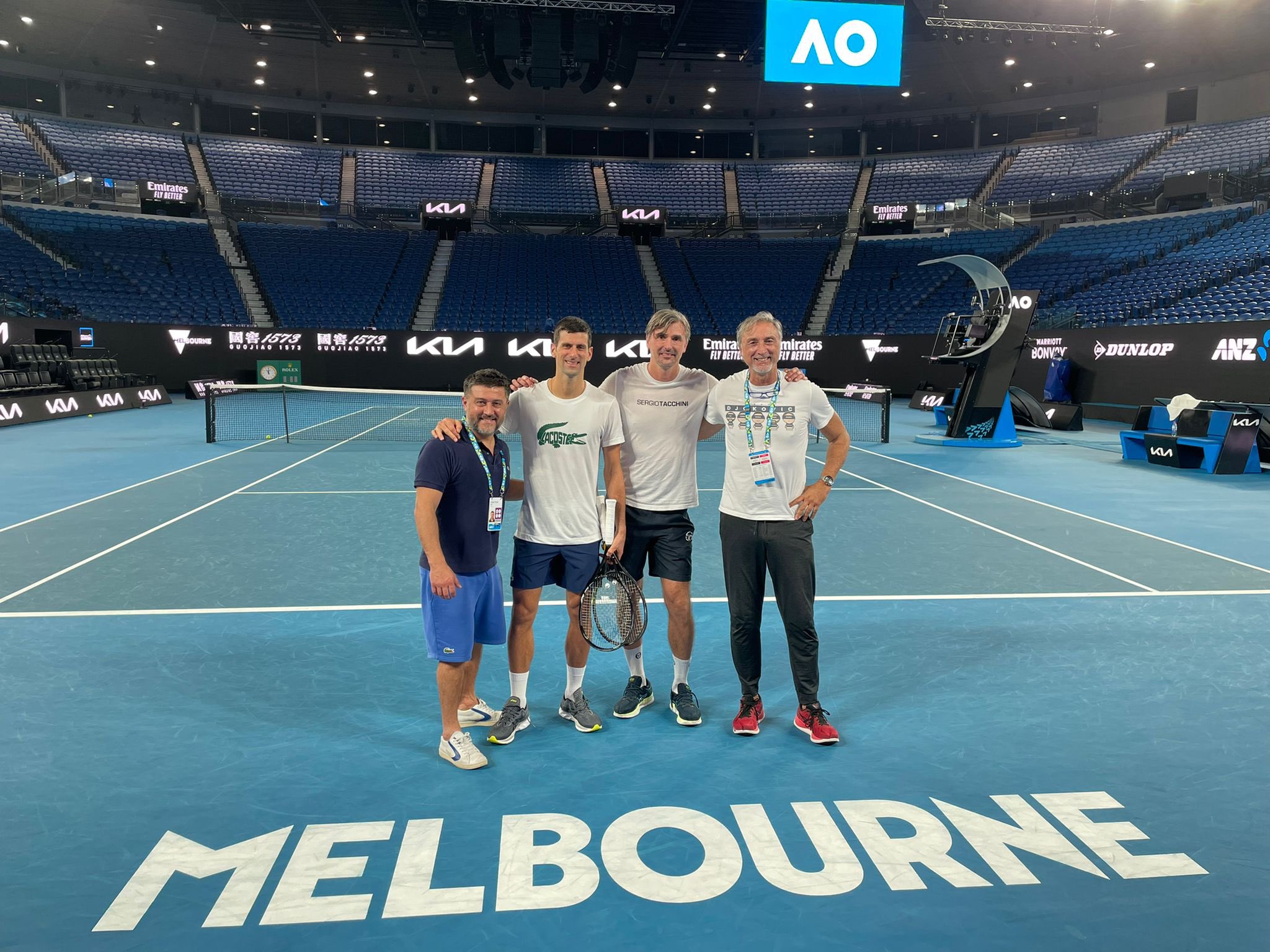 Novak Djokovis stands on a tennis court