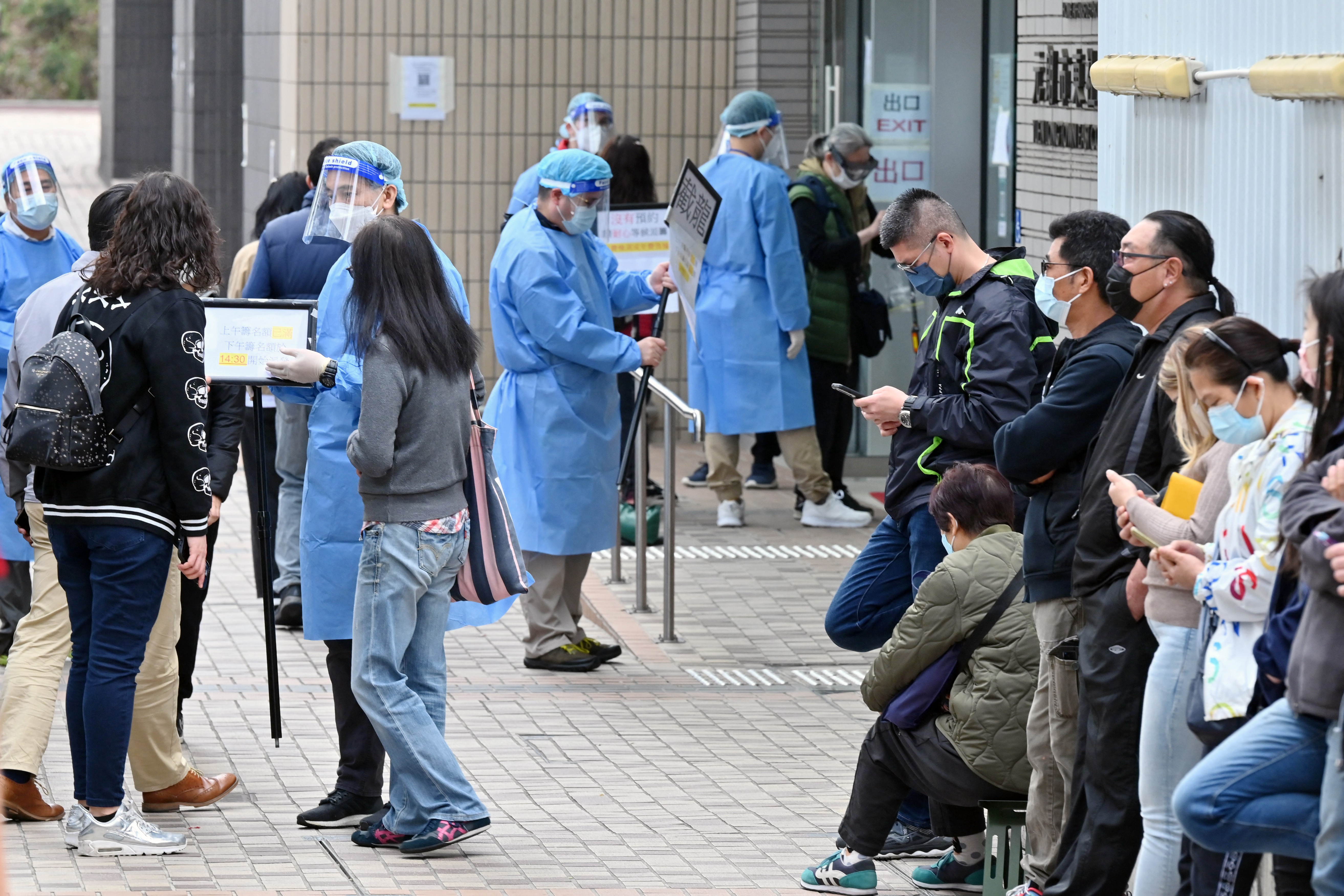 People queue for COVID-19 tests in Hong Kong’s Yuen Long as the city struggles with a wave of Omicron cases that have stretched its ‘Zero COVID’ policy to the limit