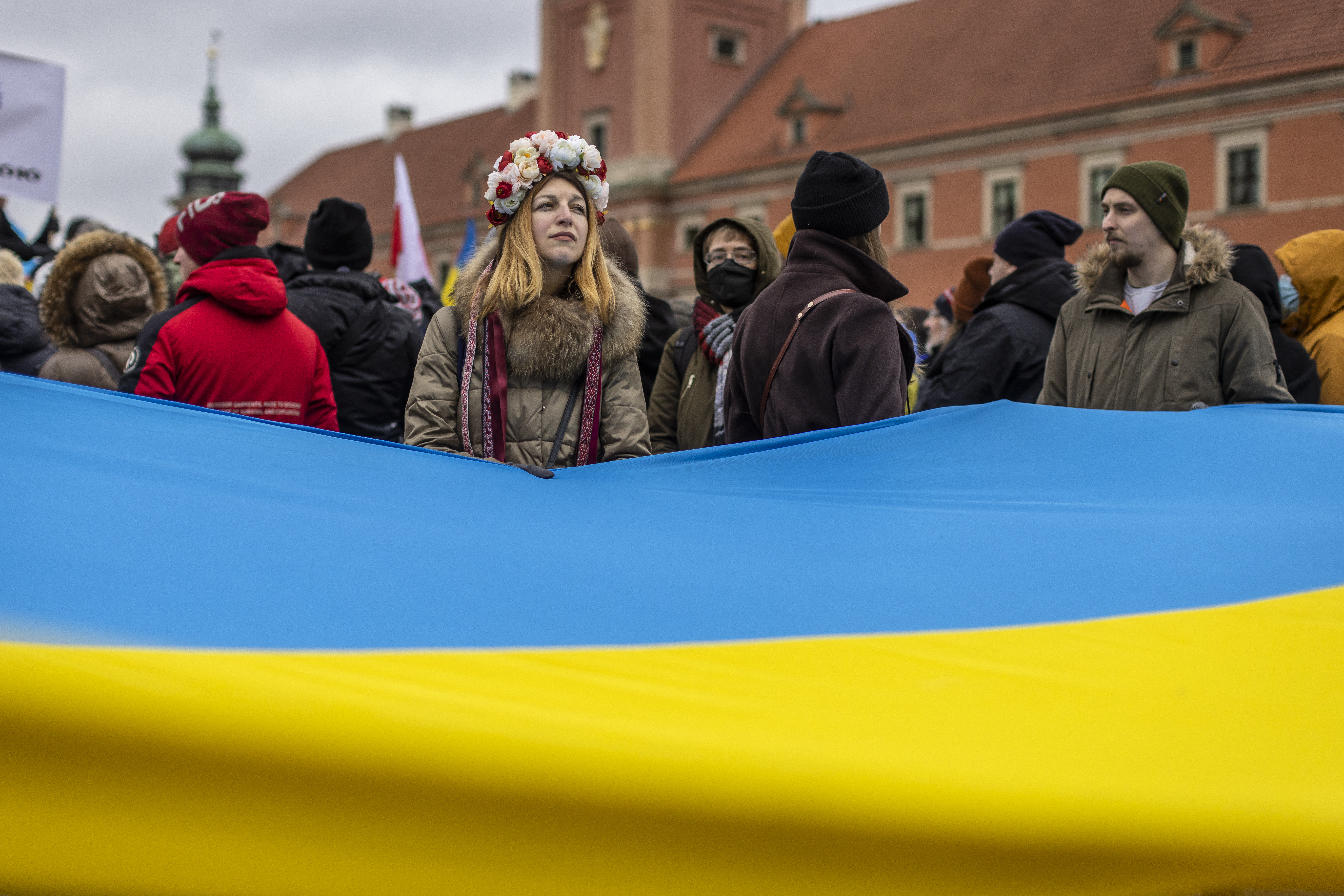 Protesters wave Ukrainian and Polish flags during a demonstration for peace in Ukraine, in Warsaw, Poland, on February 20, 2022
