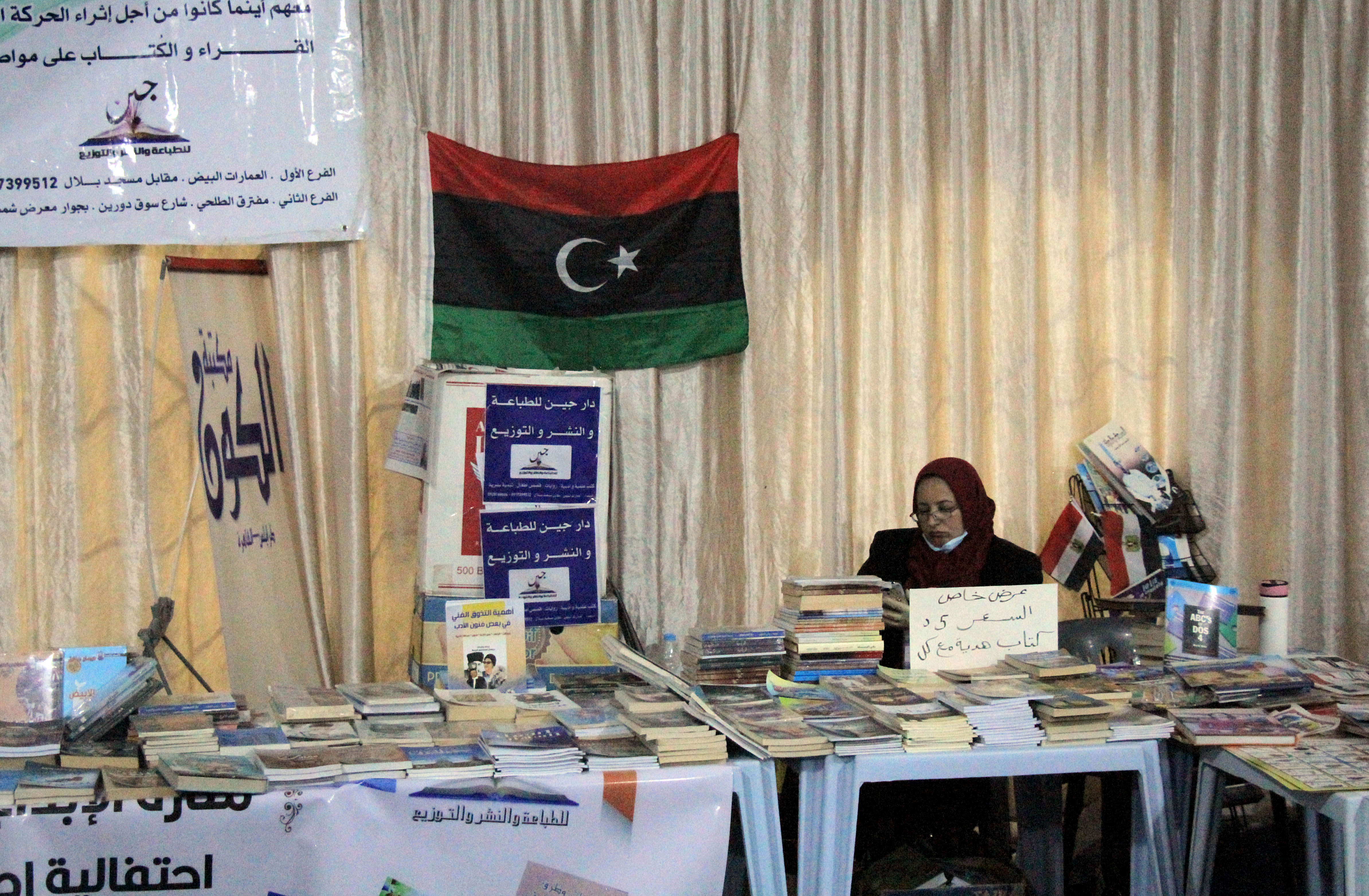 A Libyan woman sells books at Derna’s first book fair in years with the participation of more than 40 local and Arab publishing houses, held in the courtyard of the 17th-century Ottoman Atiq Mosque, on February 23, 2021