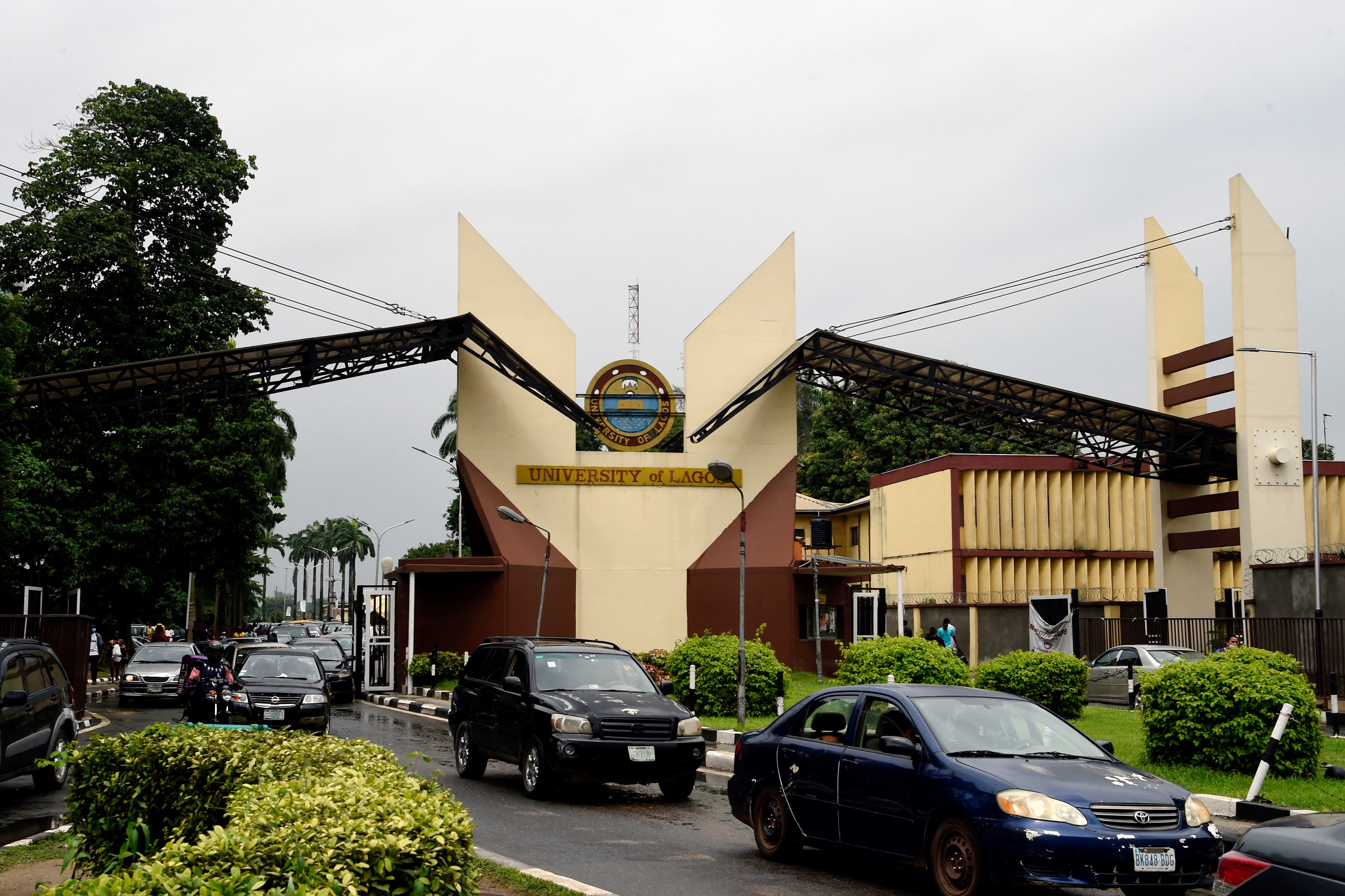 Vehicles drive past main the main gate of the University of Lagos, one of the best-known federal universities in Nigeria.