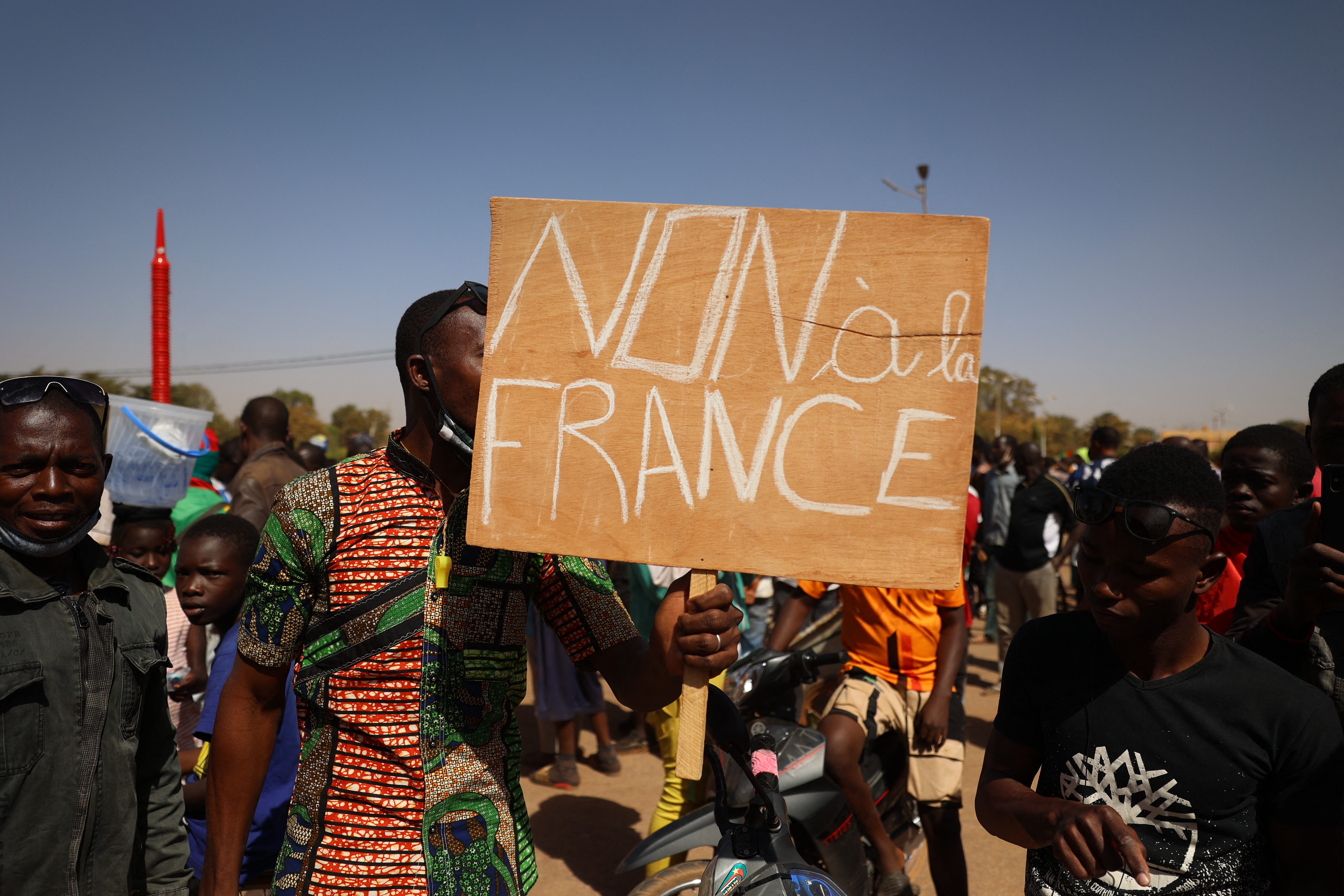 Protesters hold anti-France banner