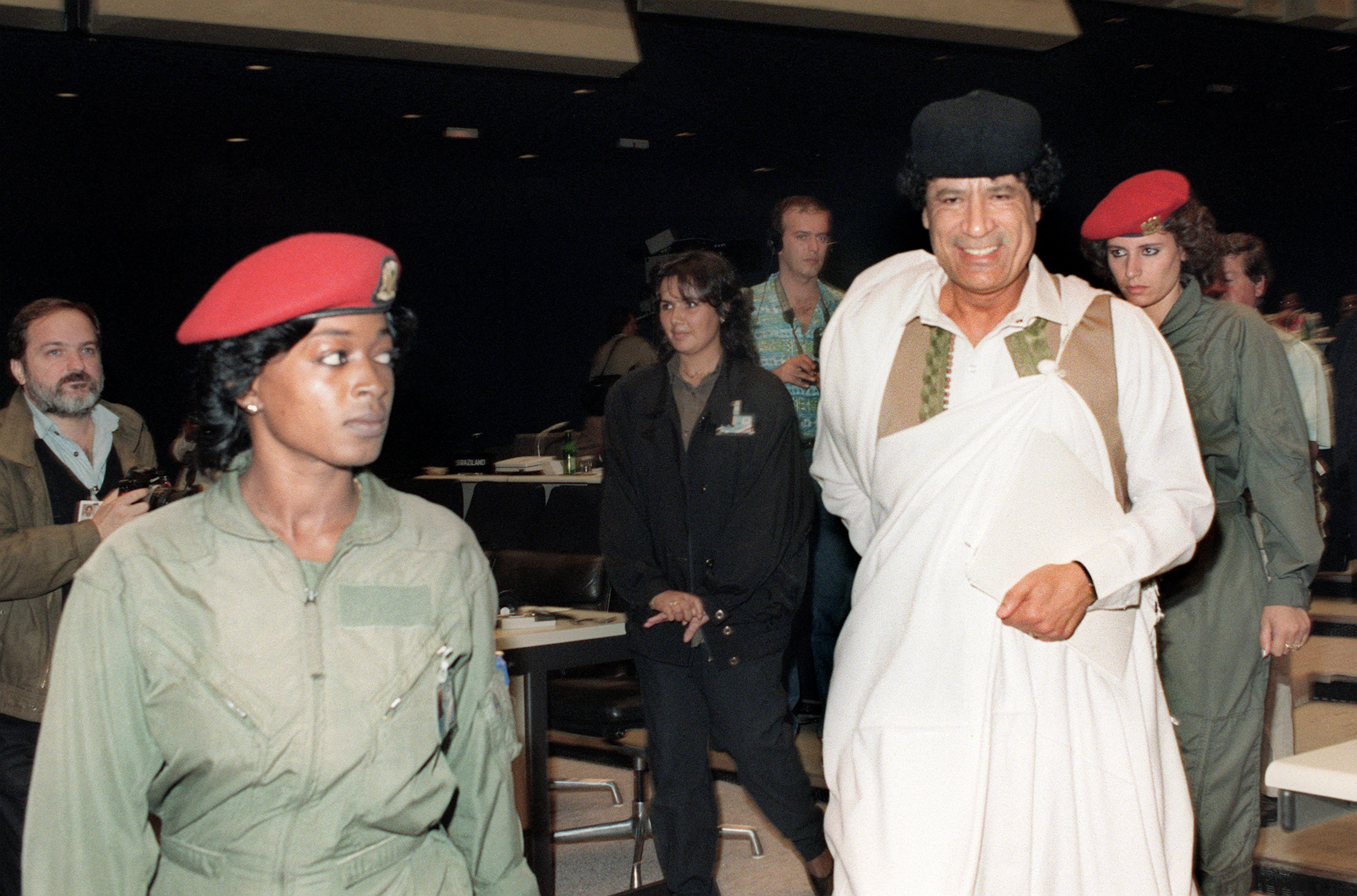 Libya’s Gaddafi, surrounded by two of his female bodyguards, enters an assembly hall in Belgrade for a session of Non-Aligned Summit in September 1989