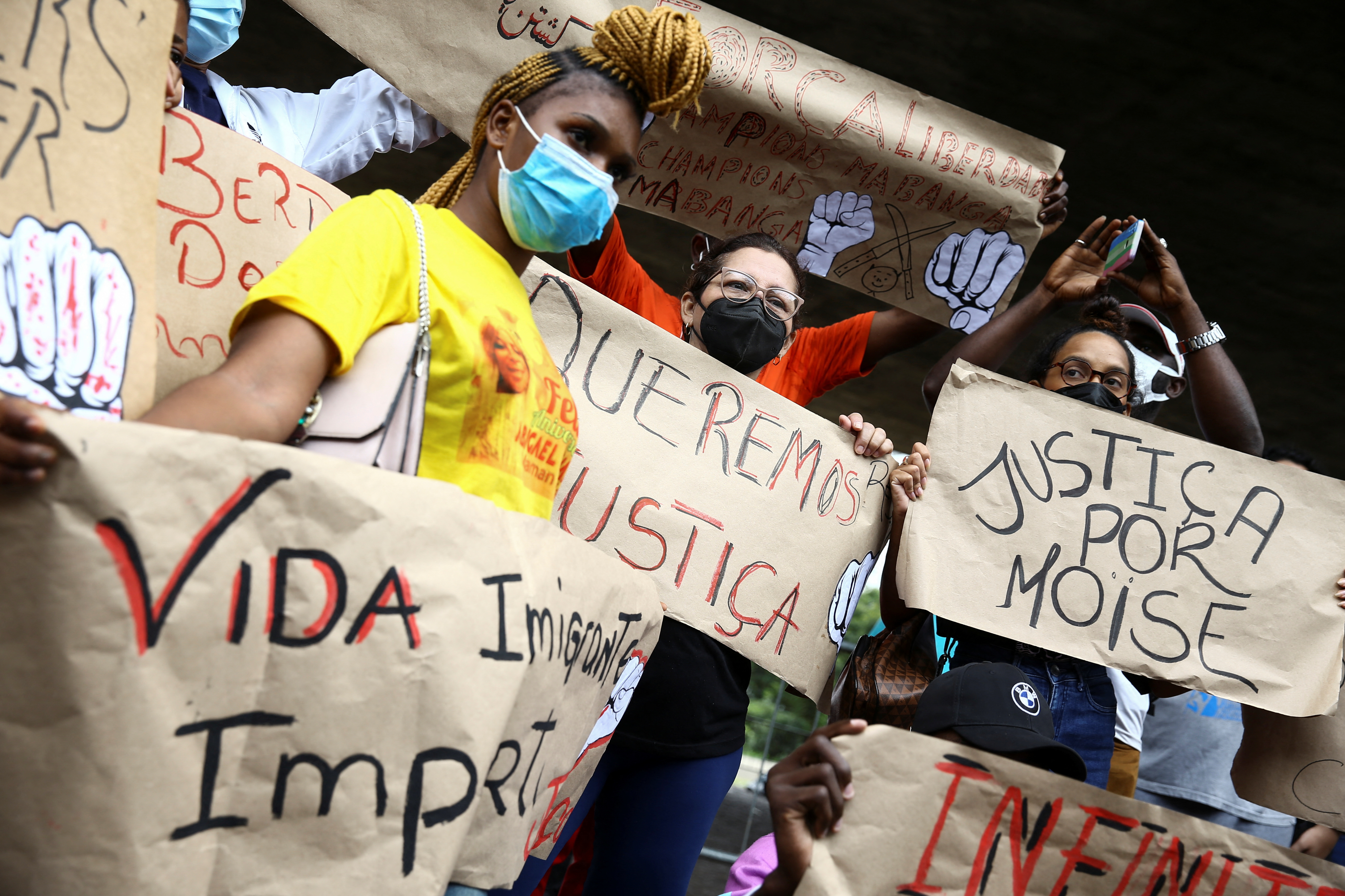 Demonstrators hold signs asking for justice after the death of a Congolese refugee Moise Kabagambe, who was brutally killed in Rio de Janeiro, during a protest in Sao Paulo, Brazil