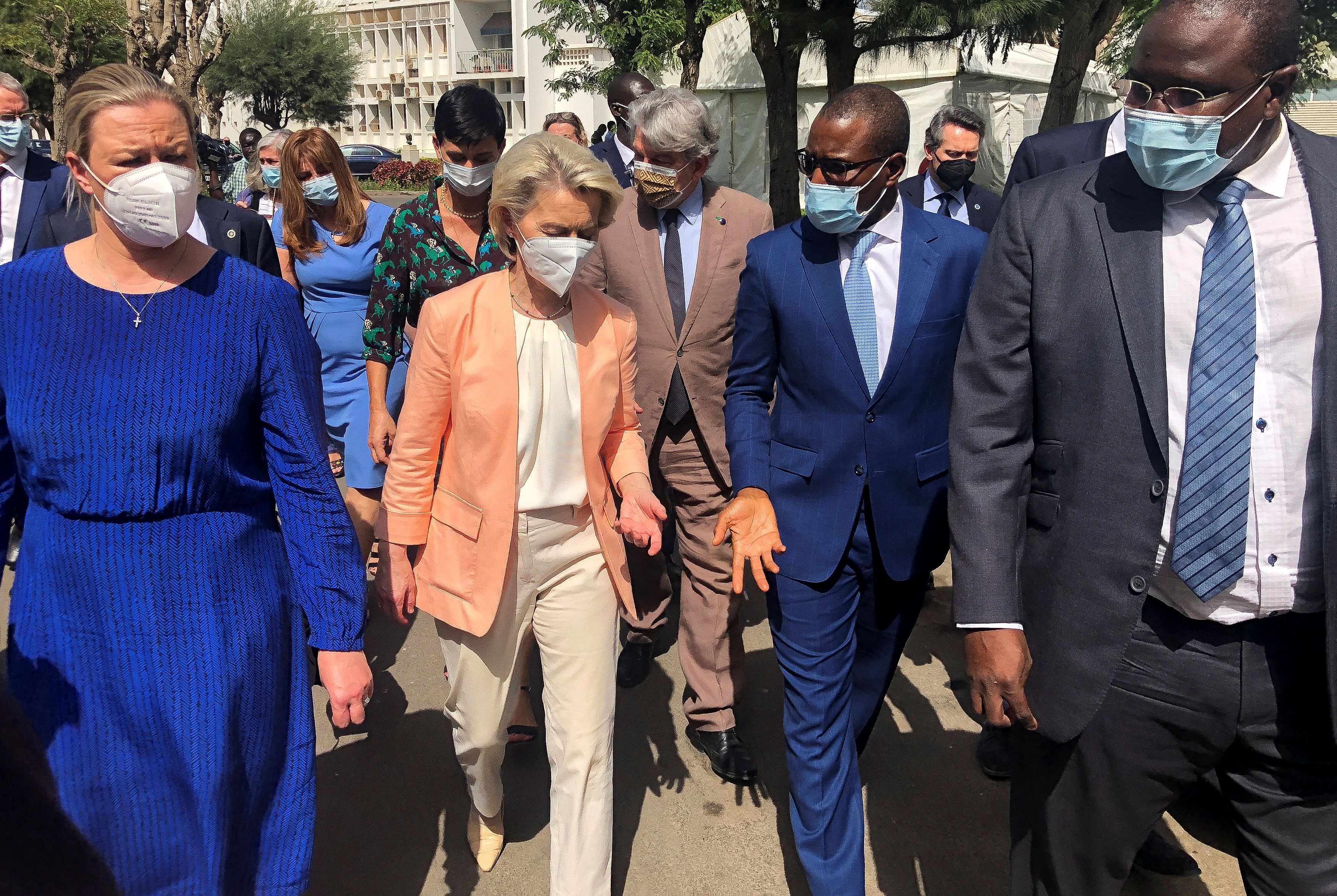 European Commission President Ursula von der Leyen speaks to officials during a tour of the Pasteur Institute vaccination and testing facility, in Dakar, Senegal
