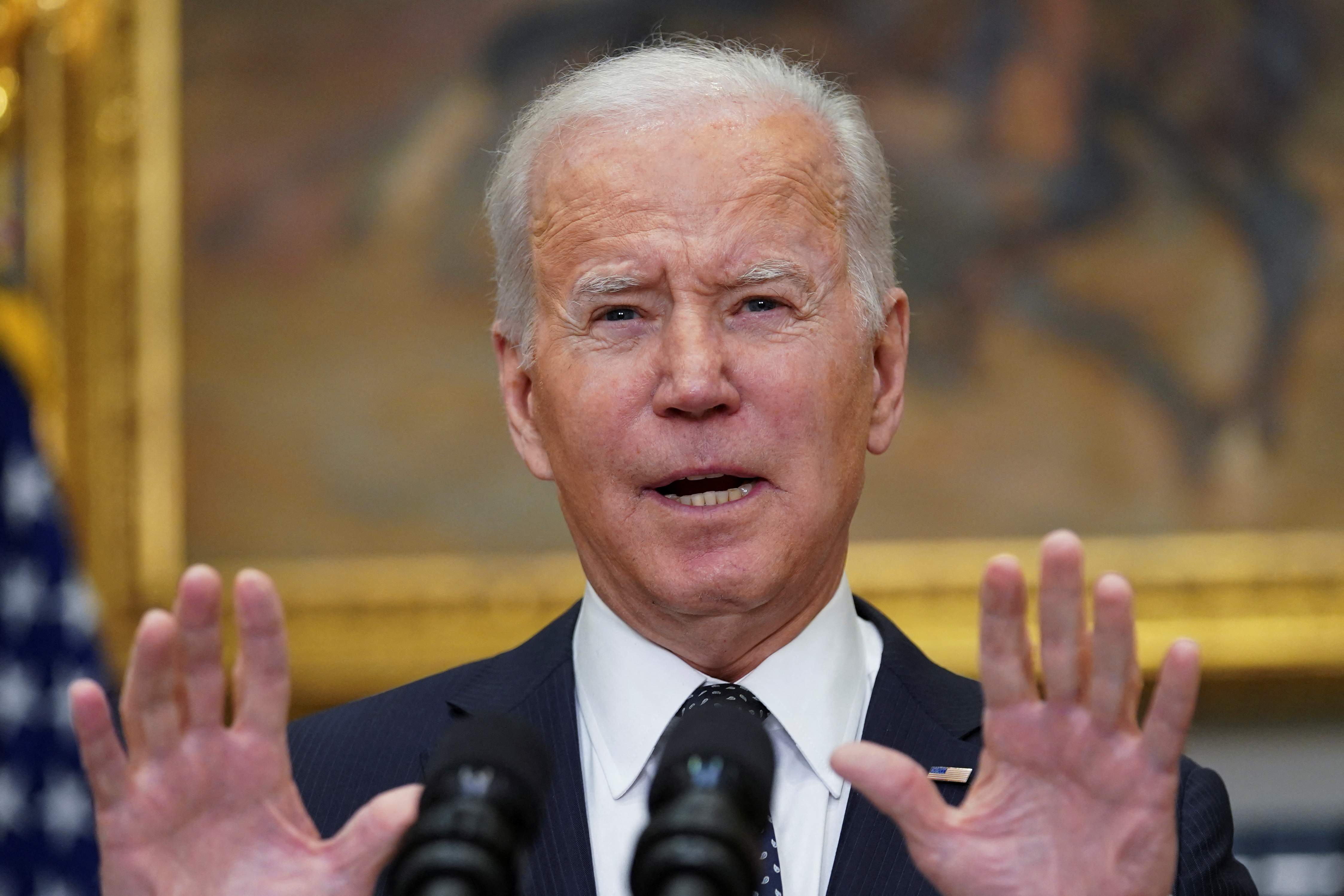 US President Joe Biden speaks at a podium