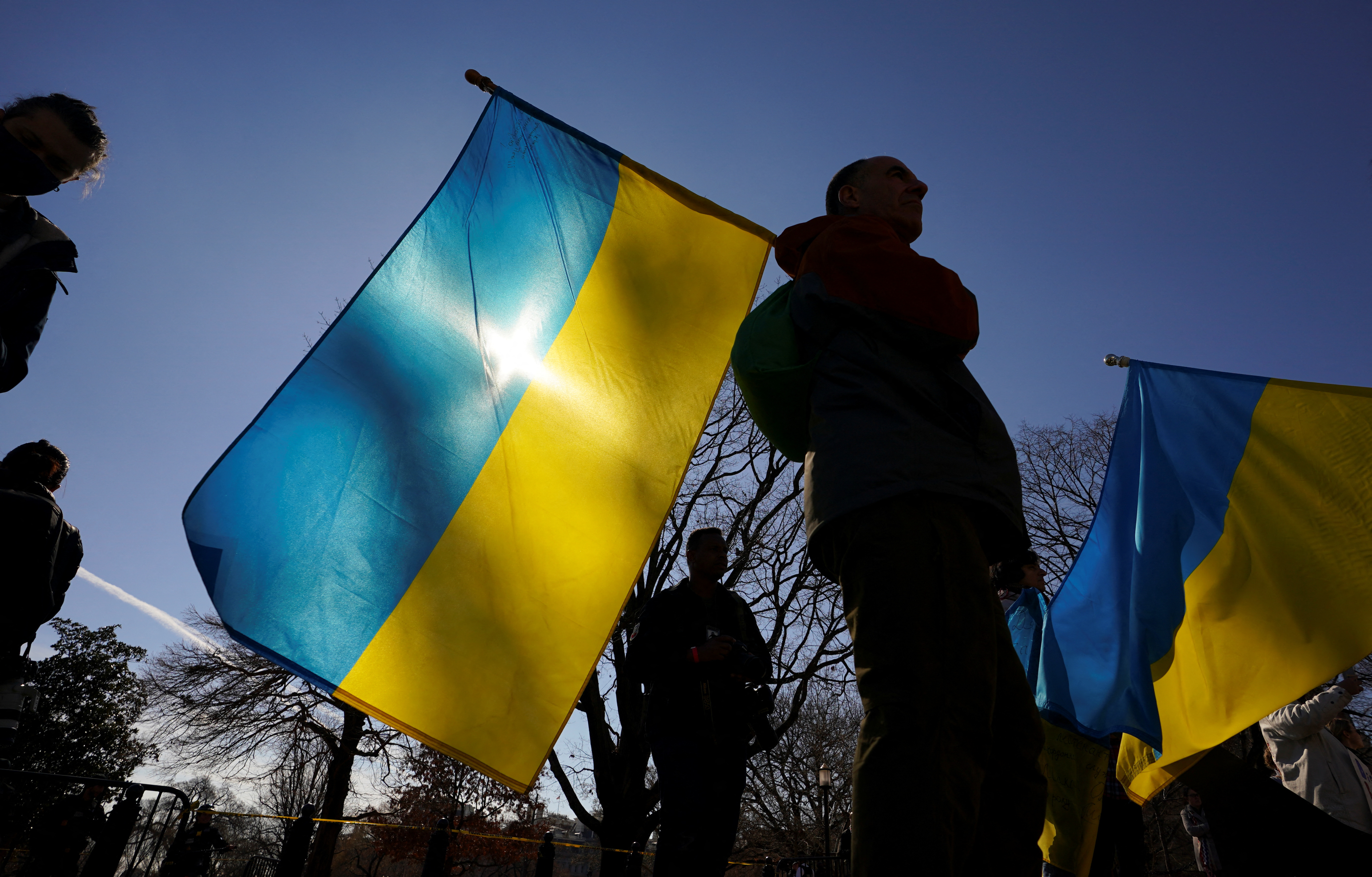 A man holds a Ukraine flag during a demonstration in front of the White House to support Ukraine and protest Russia's invasion of the country, in Washington, U.S.,