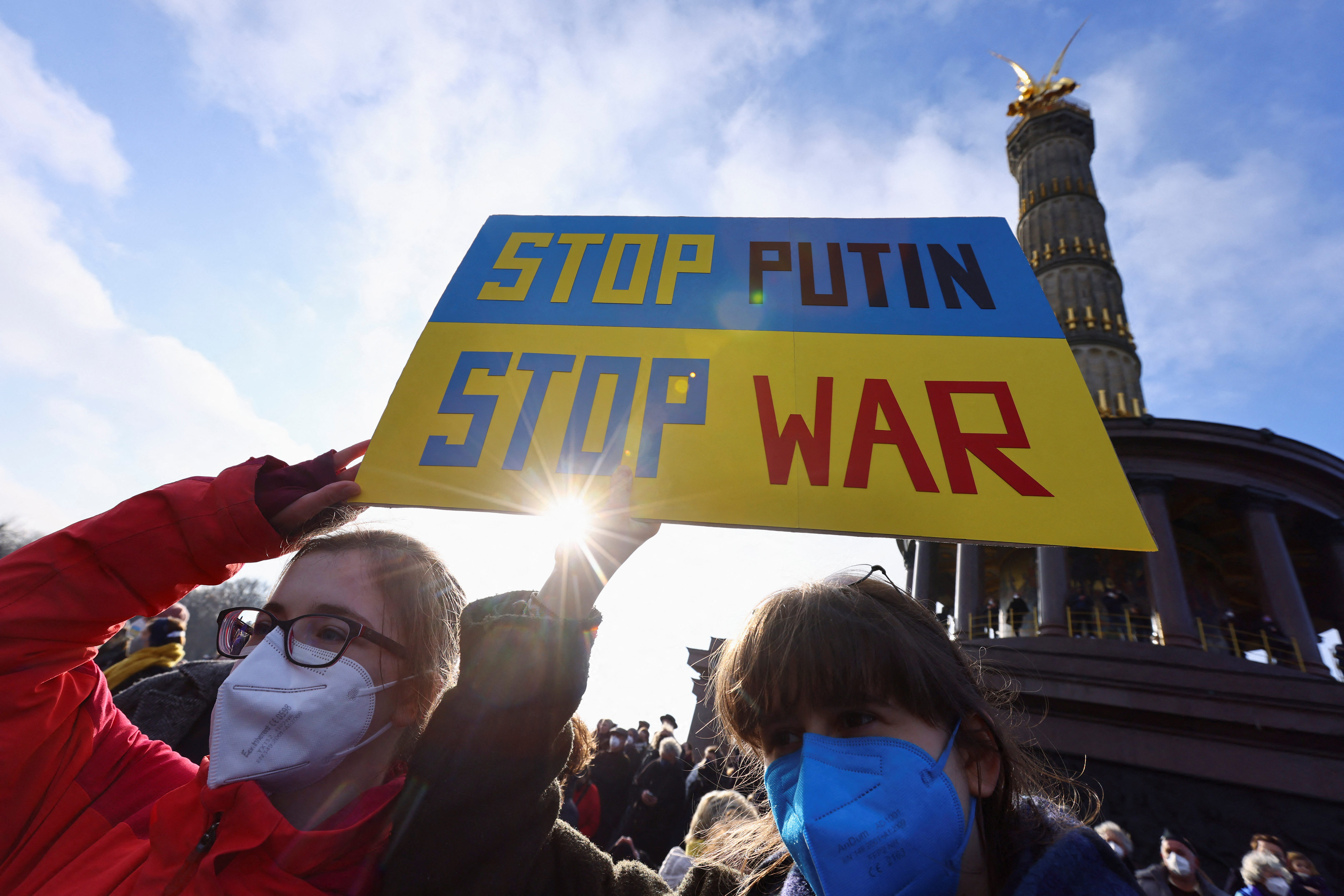 Demonstrators hold a placard as they take part in an anti-war protest in Berlin