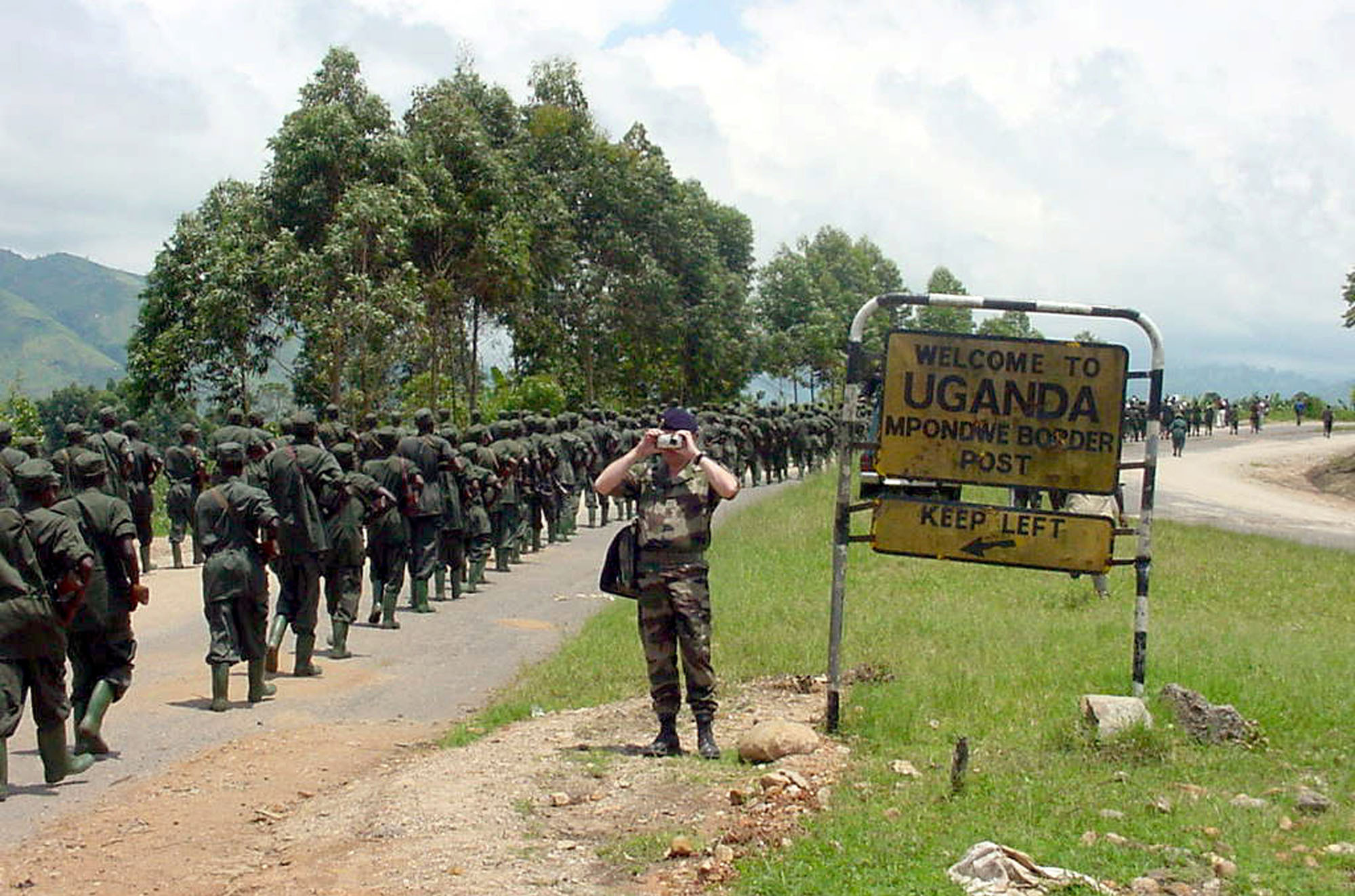 Ugandan soldiers who had been fighting rebels in DR Congo for the previous three years, cross back into Uganda at the Mpondwe border point on October 15, 2001