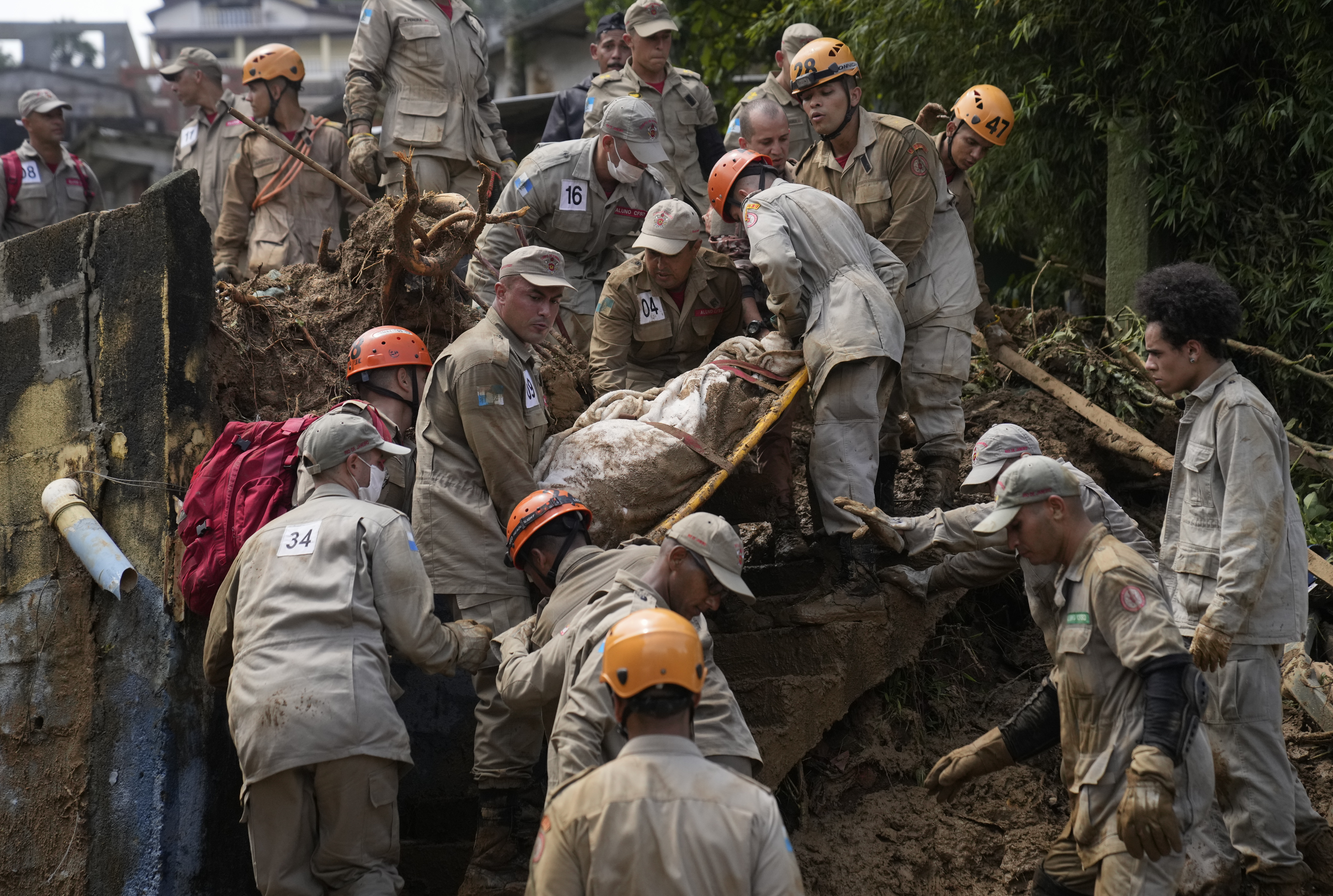 Rescue workers recover the body of a mudslide victim in Petropolis