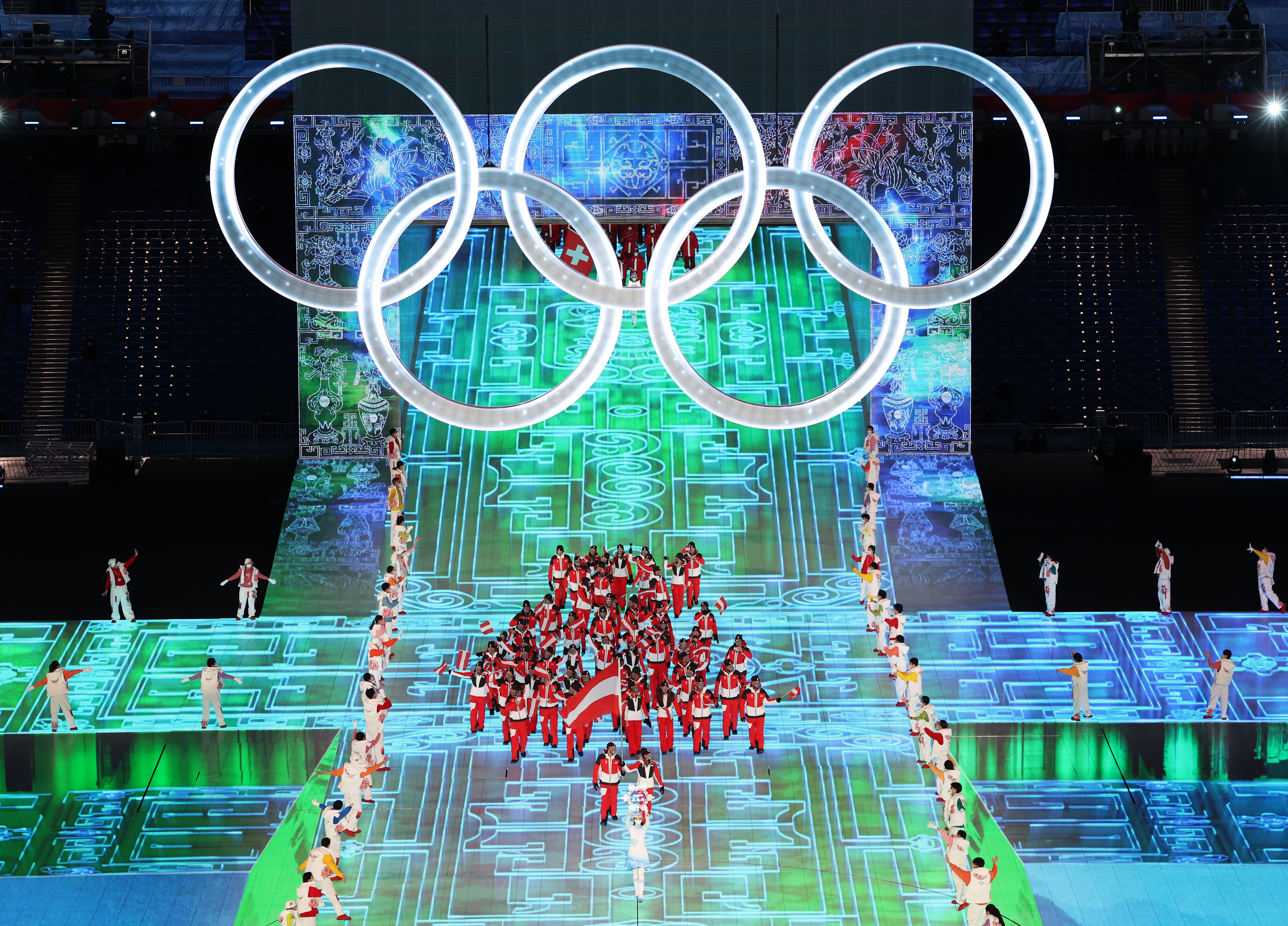 Flag bearers Julia Dujmovits and Benjamin Maier of Team Austria carry their flag during the Opening Ceremony