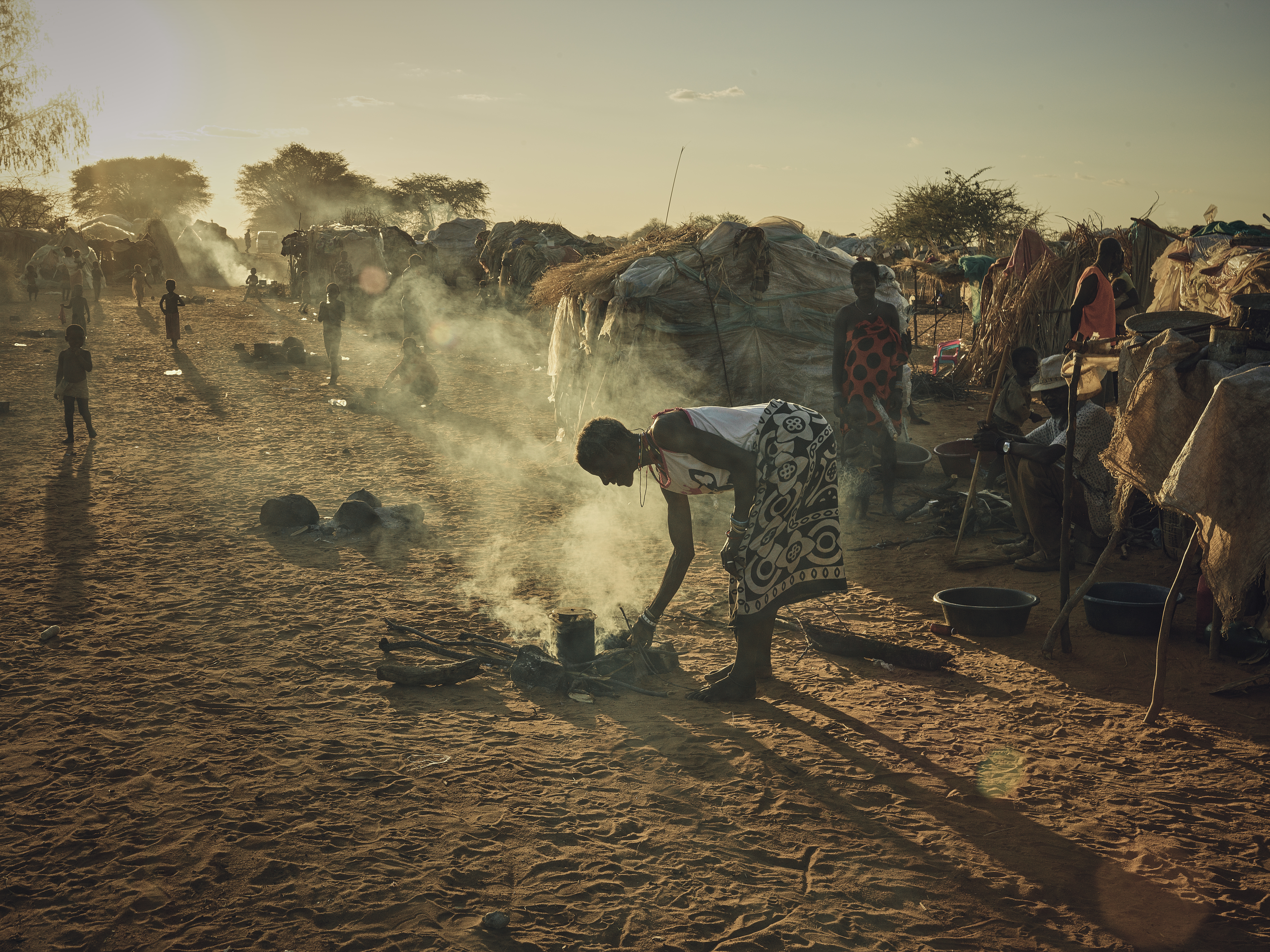 A photo of a woman cooking at the Etunda Refugee Camp.