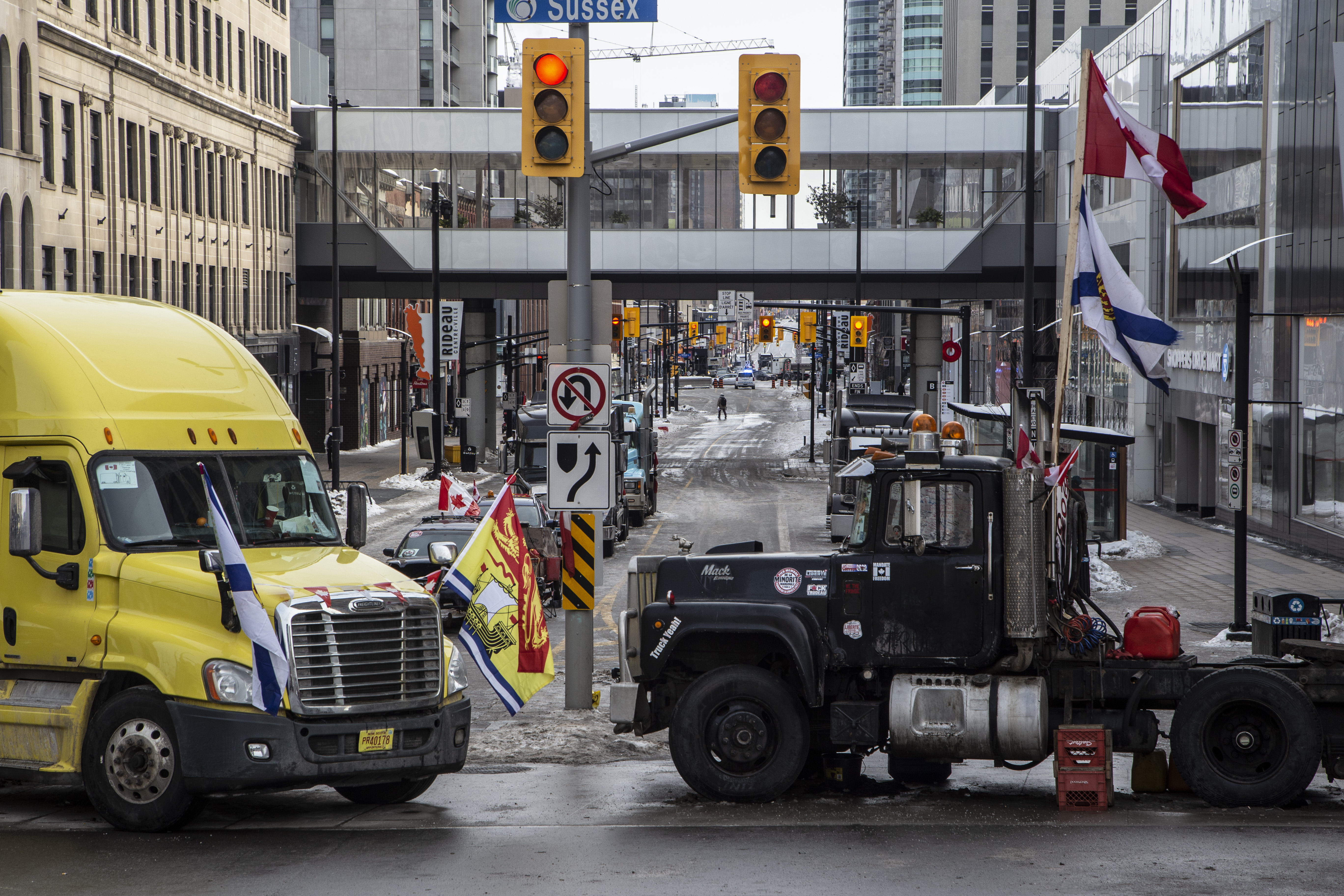 Two trucks block the entrance to Rideau street, one of the main commercial streets of downtown Ottawa