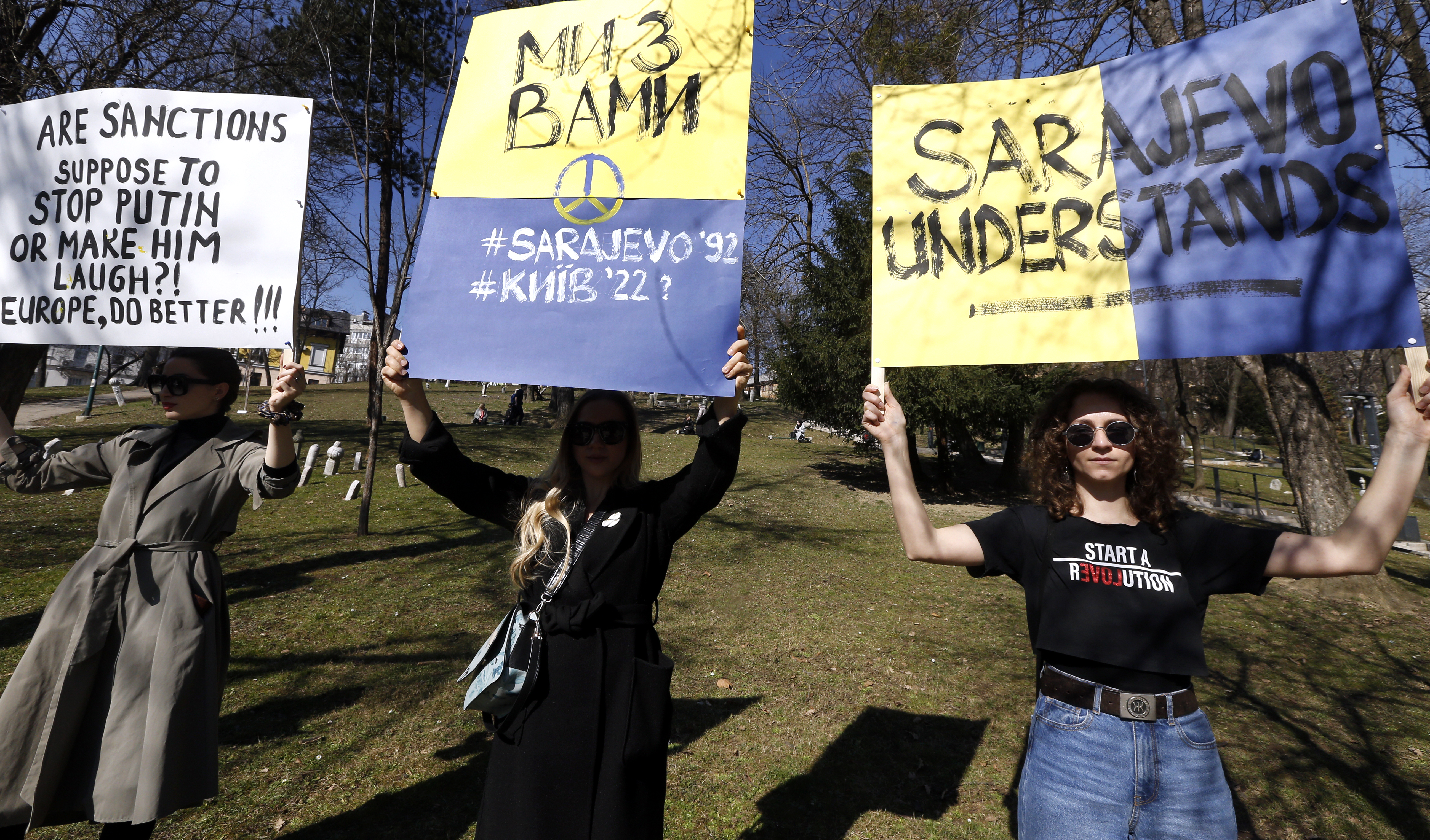 Bosnian women carry placards as they attend a protest against Russia’s attack on Ukraine in Sarajevo, Bosnia and Herzegovina