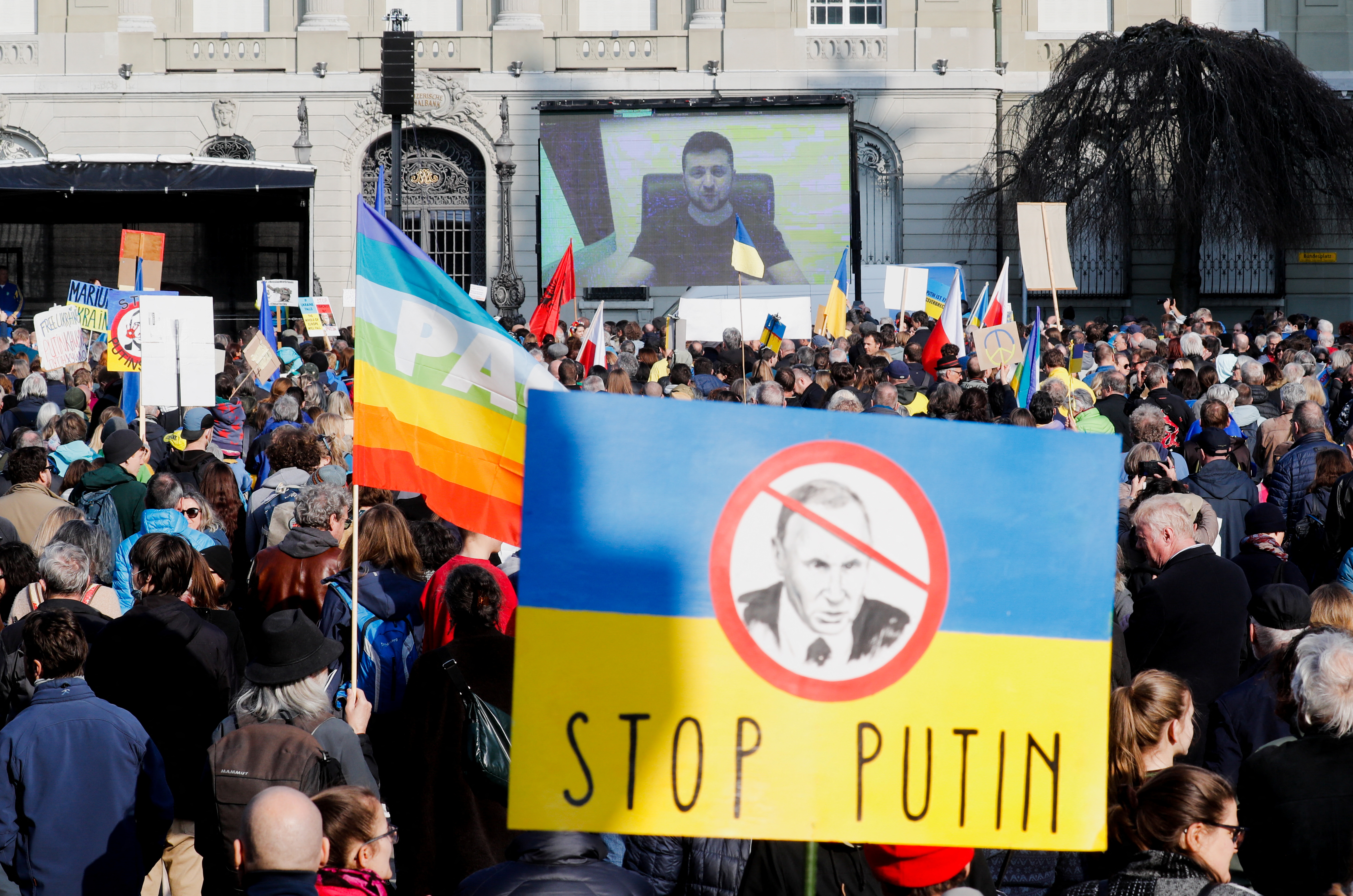Demonstrators rally for peace in front of the seat of the Swiss Bundeshaus, in Bern