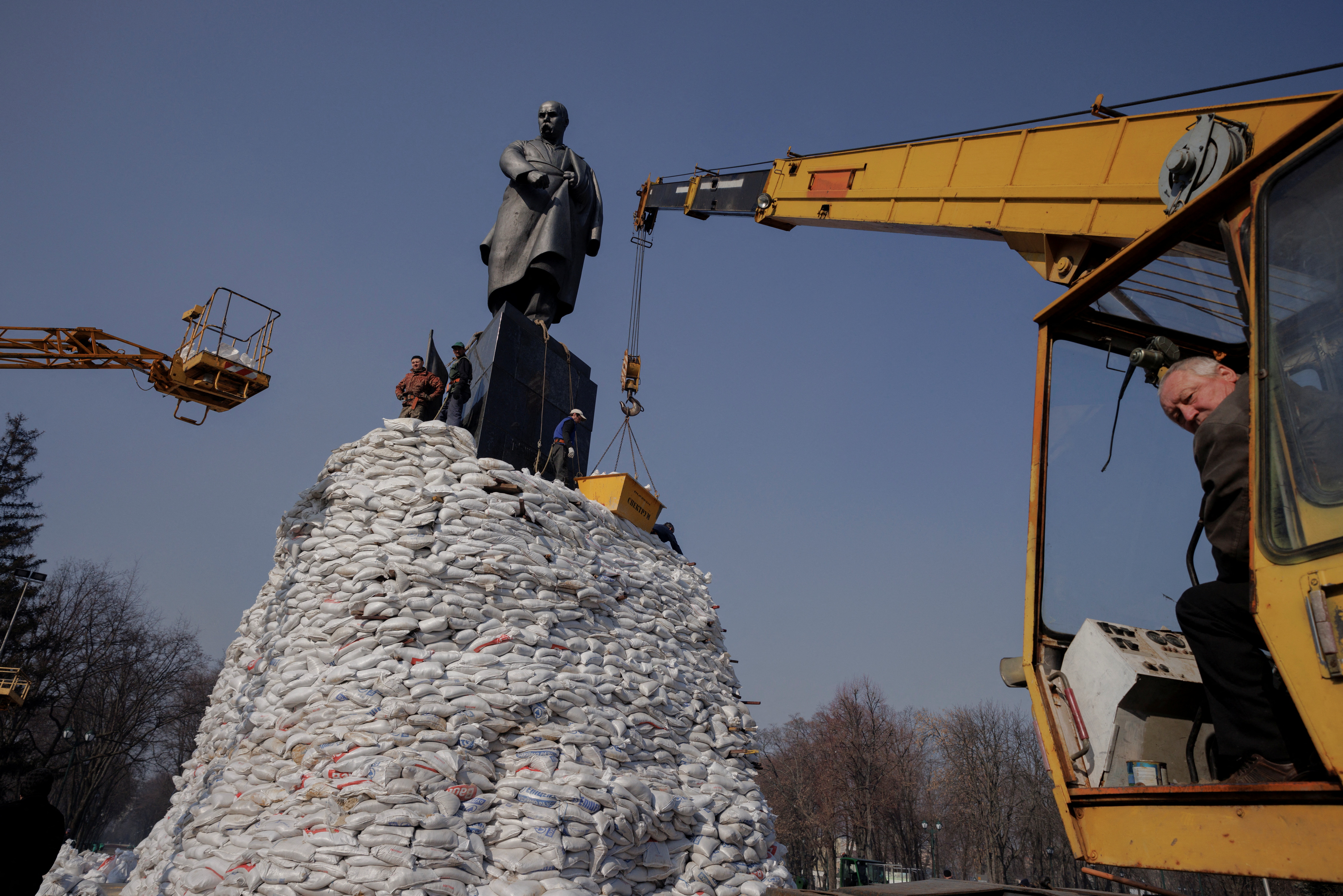 People in Kharkiv pile up sandbags around a monument to Ukrainian poet Taras Shevchenko to protect it from shelling