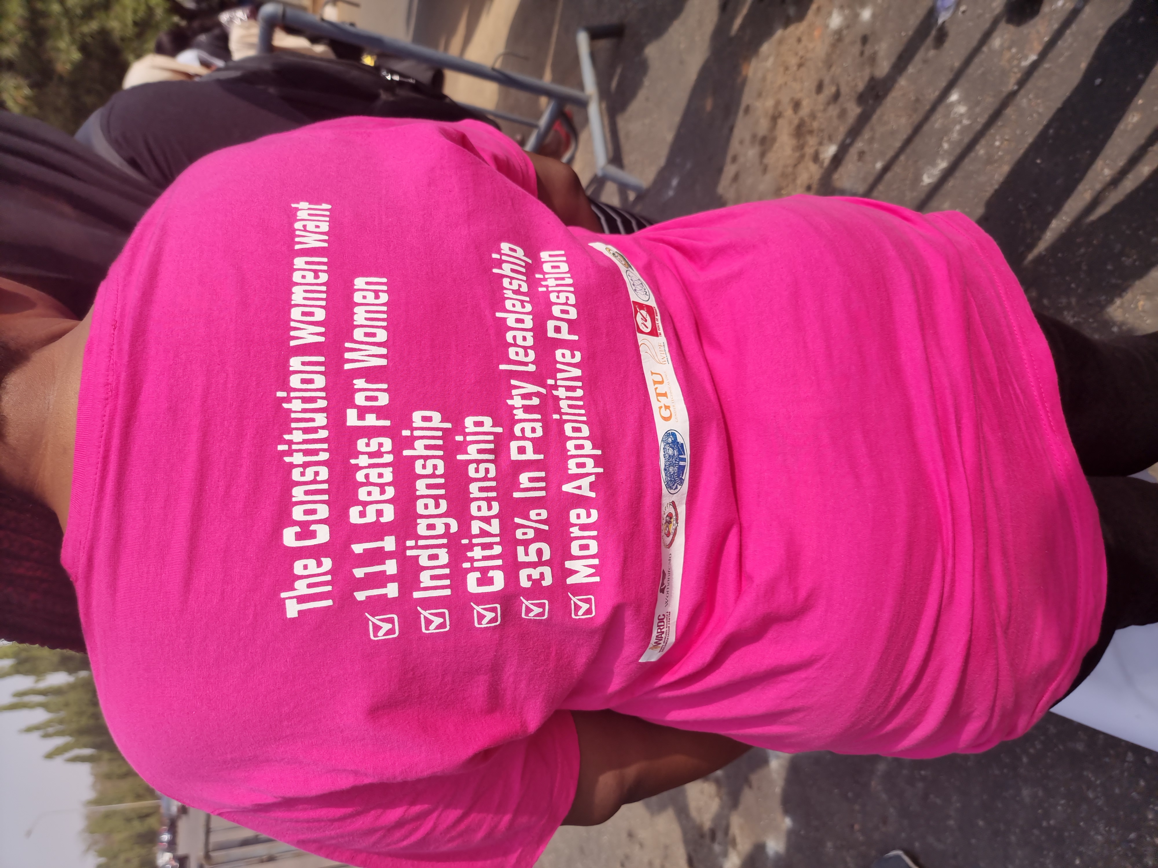 A Nigerian women uses her shirt to outline demands of her and fellow female protestors at the gates of the Nigerian parliament after a constitutional amendment session.