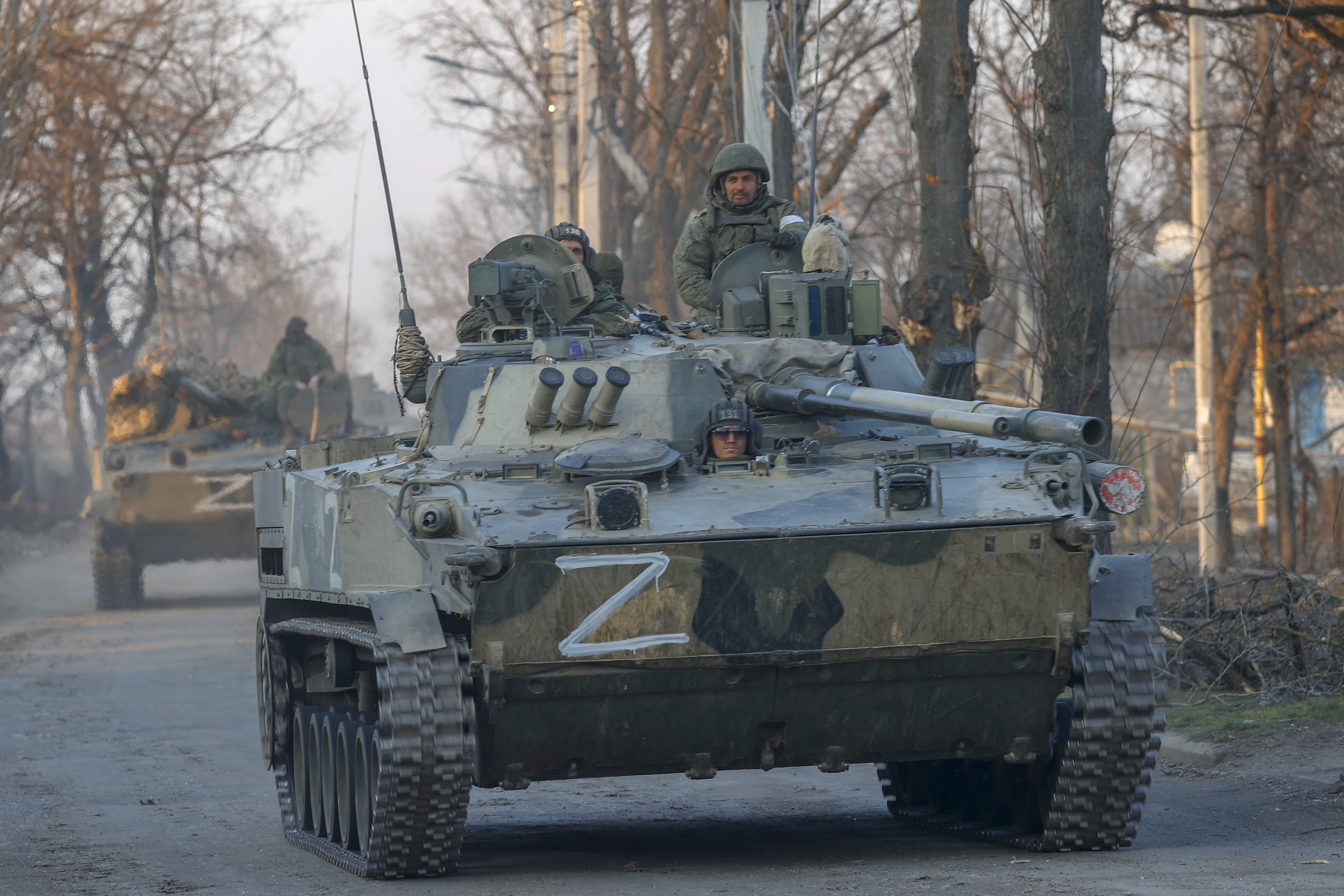 Russian soldiers are seen on a tank