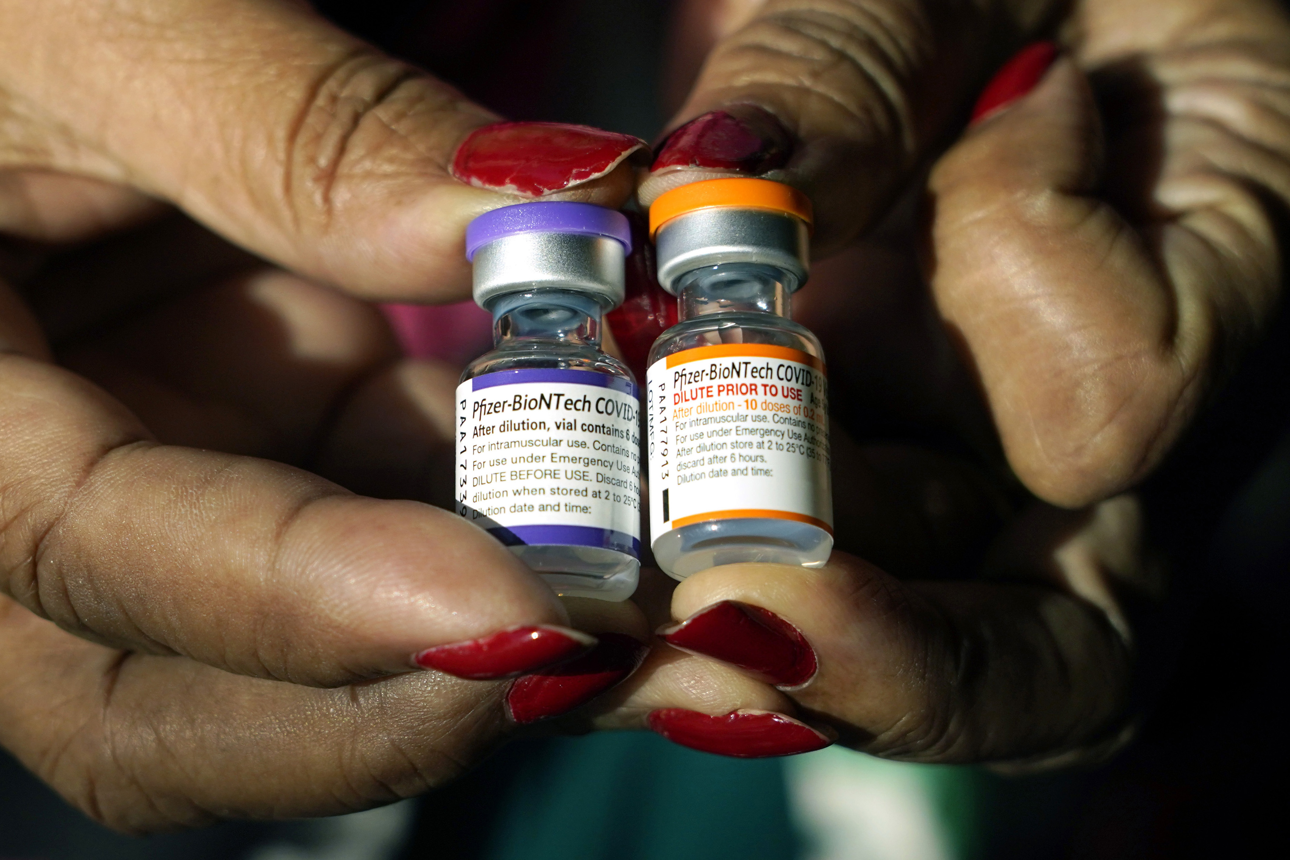 A nurse holds a vial of the Pfizer COVID-19 vaccine for children ages 5 - 11, right, and a vial of the vaccine for adults, which have different colored labels, at a vaccination station in Jackson, Miss., Tuesday, Feb. 8, 2022. Pfizer’s COVID-19 vaccine gave children 5 and older strong protection against hospitalization and death even during the omicron surge that hit youngsters especially hard, according to new data from the Centers for Disease Control and Prevention released on Tuesday, March 1, 2022