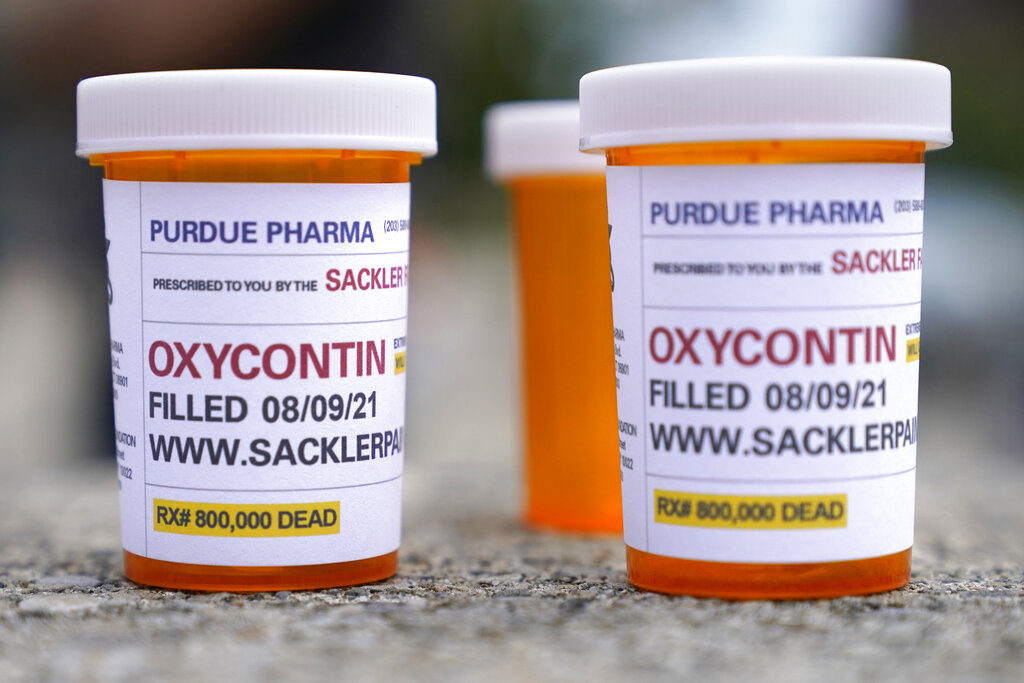 Fake pill bottles with messages about OxyContin maker Purdue Pharma are displayed during a protest outside the courthouse where the bankruptcy case of the company is taking place in White Plains, New York