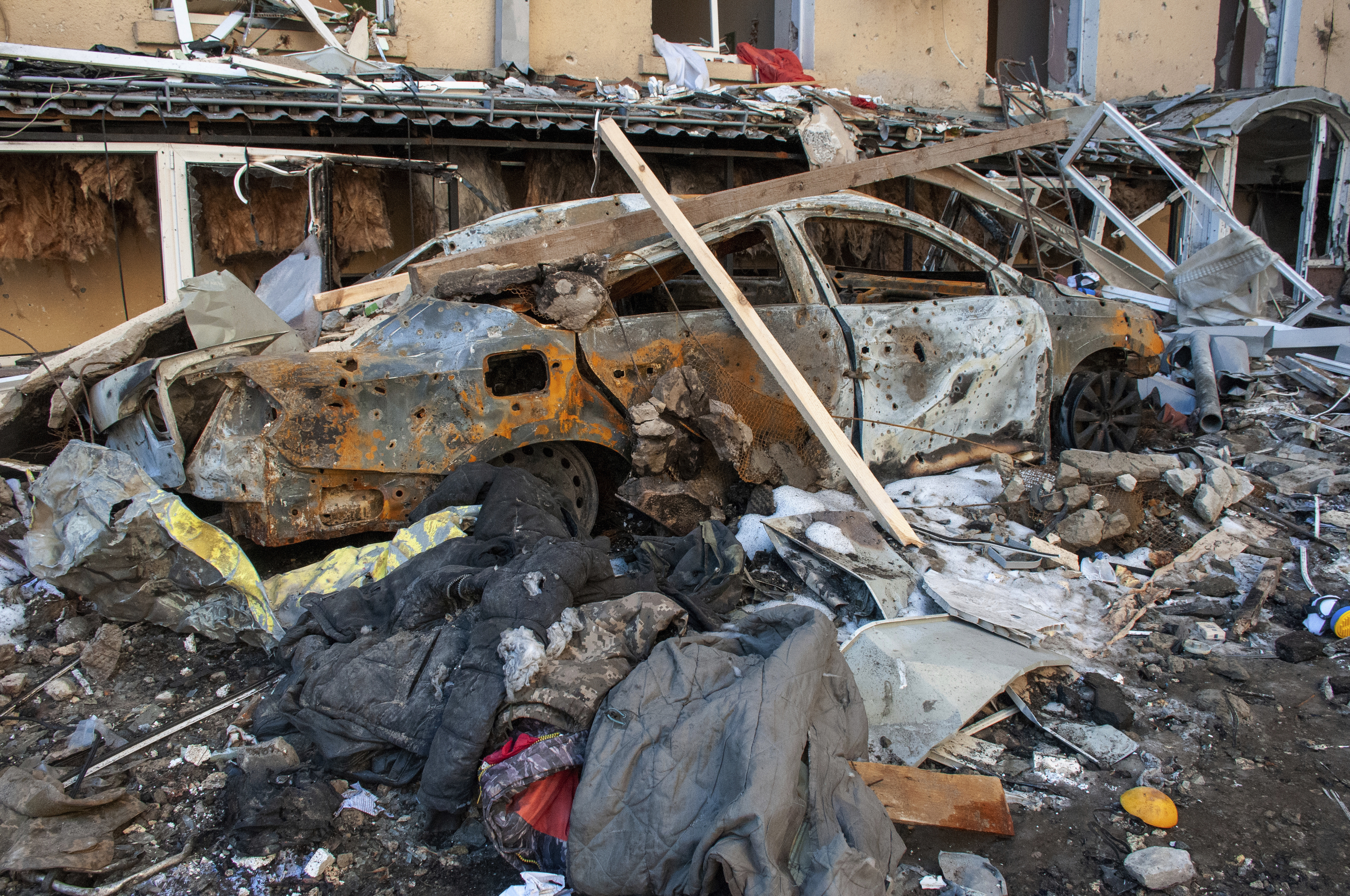 A car destroyed by shelling is seen in a street in Kharkiv,
