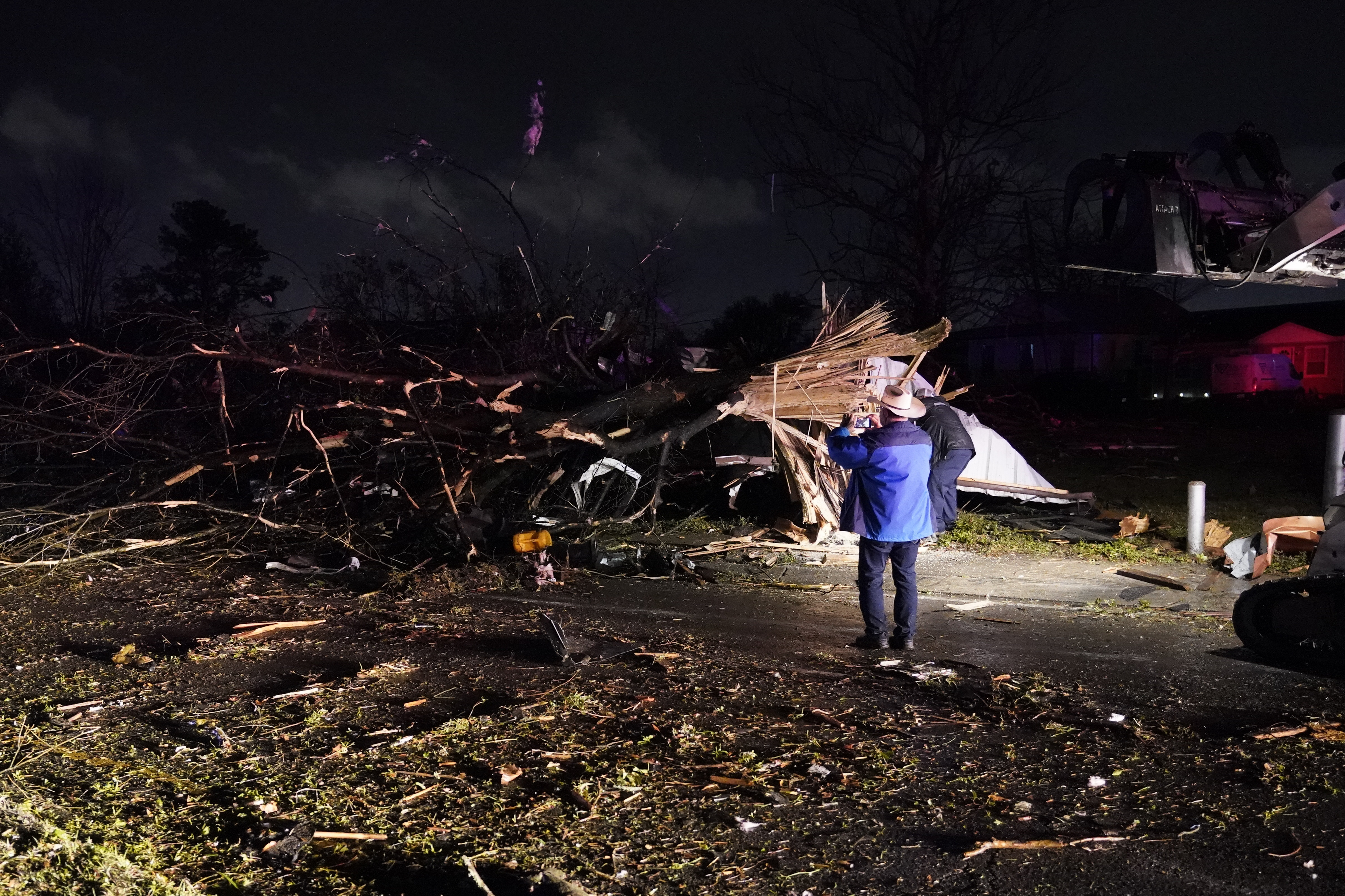 A person takes a photo of damage in Arabi, Louisiana