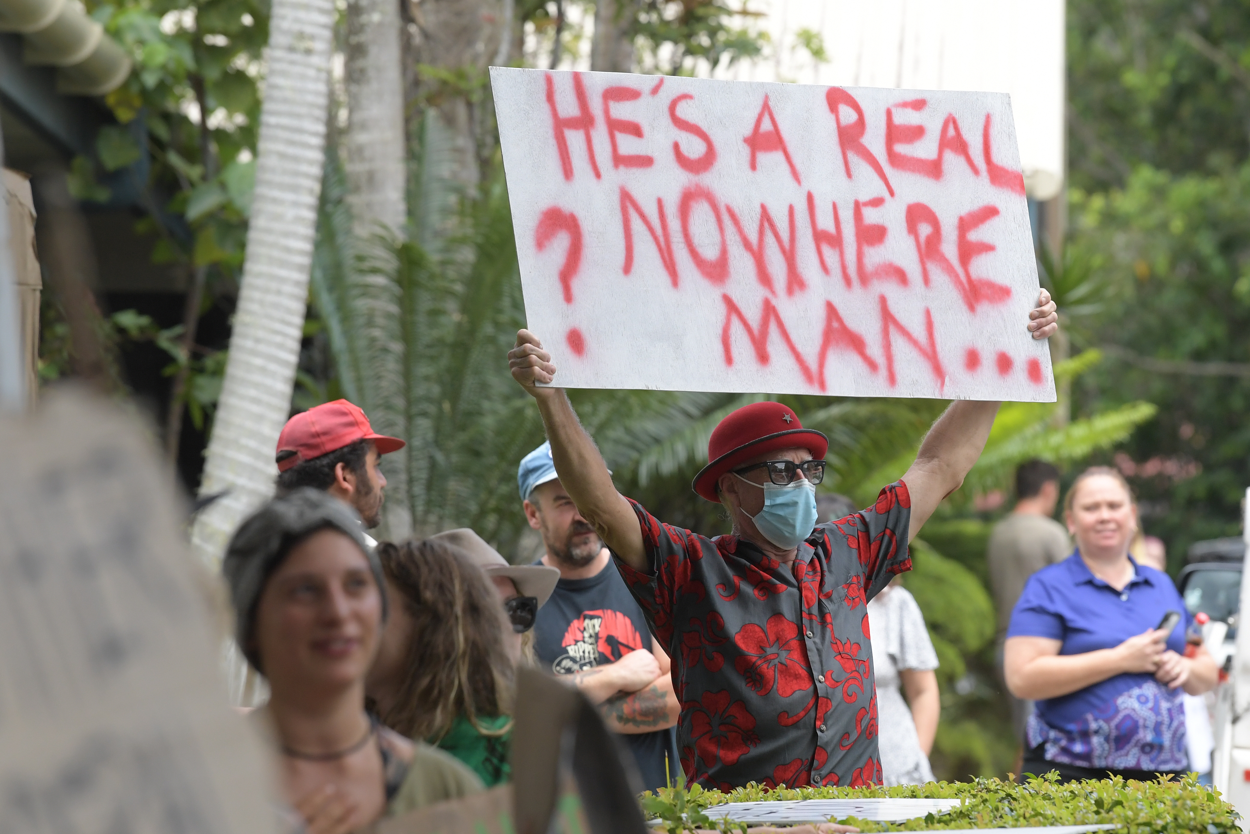 Local residents protest as they wait for Prime Minister Morrison during a visit to the Emergency Operations Centre in Lismore