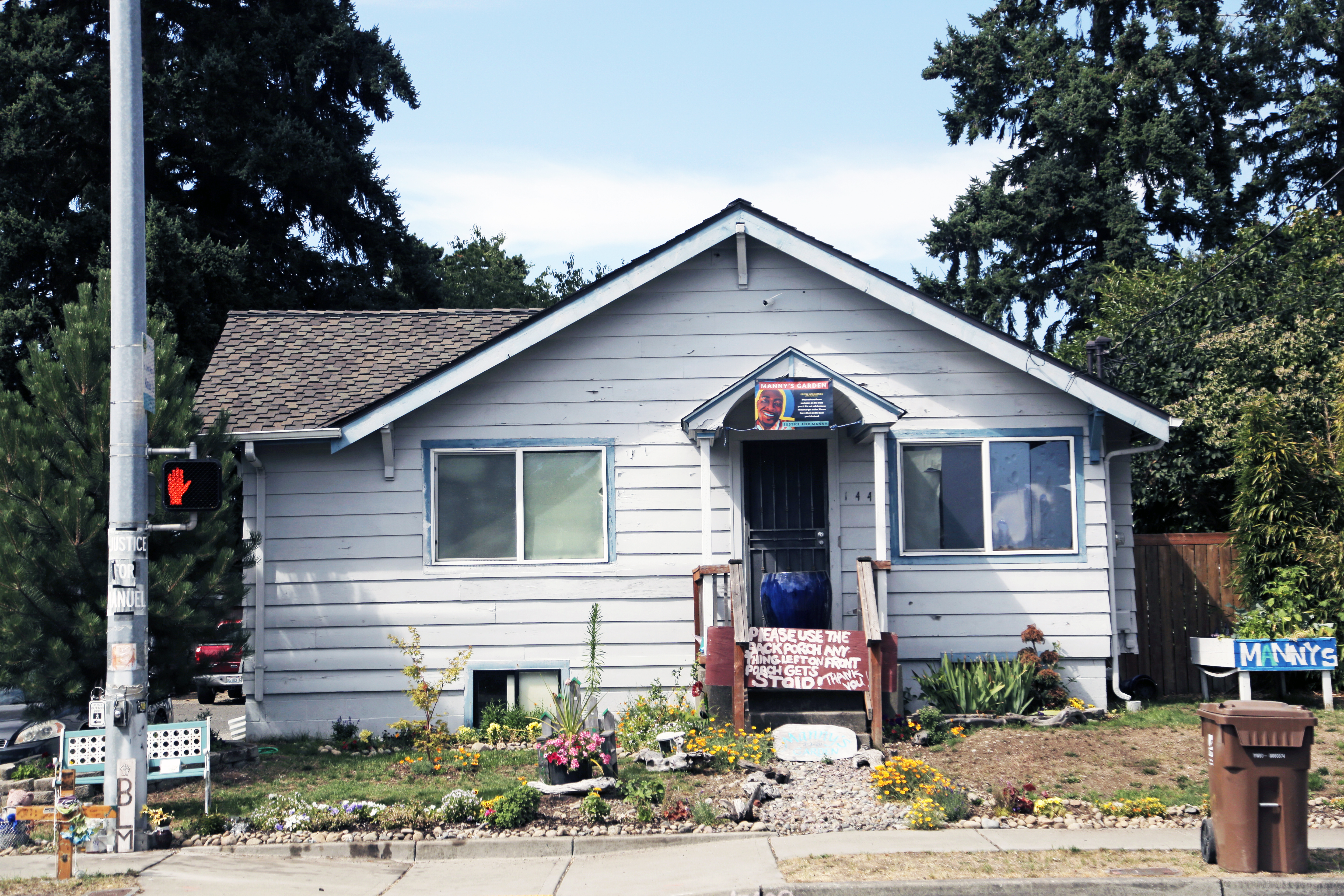 The front yard of the vacant south Tacoma home, footsteps from where Manuel Ellis died, has been turned into a memorial garden