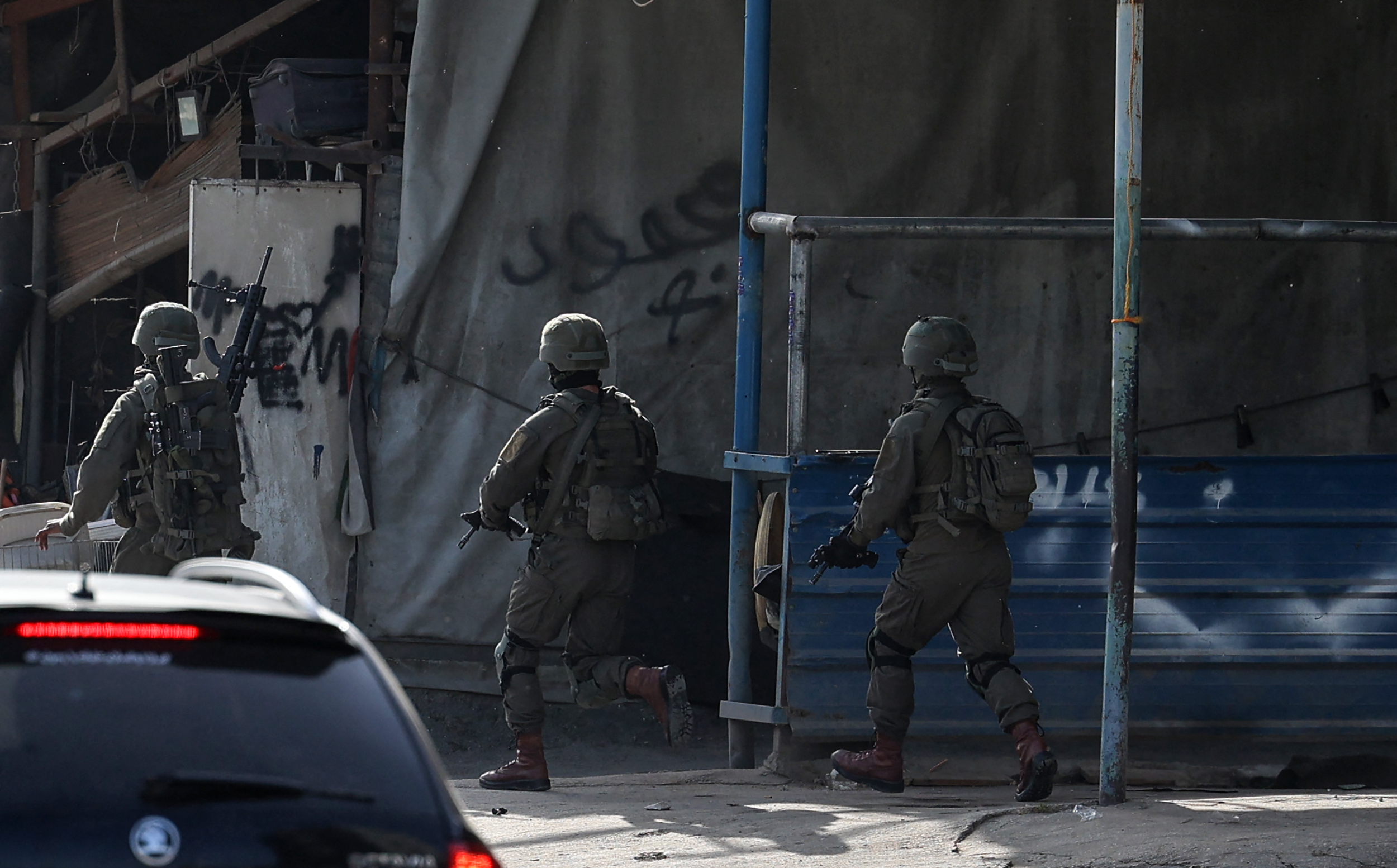 Israeli troops take position in the Nur Shams Palestinian refugee camp in the northern occupied West Bank town of Tulkarem during a raid