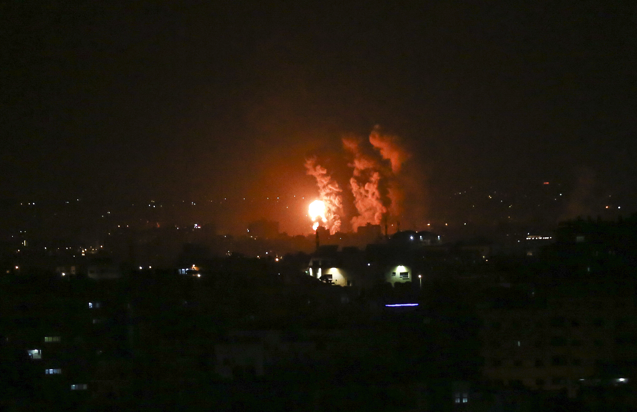 Flames and smoke rise during Israeli airstrikes central Gaza strip in on April 21, 2022. -